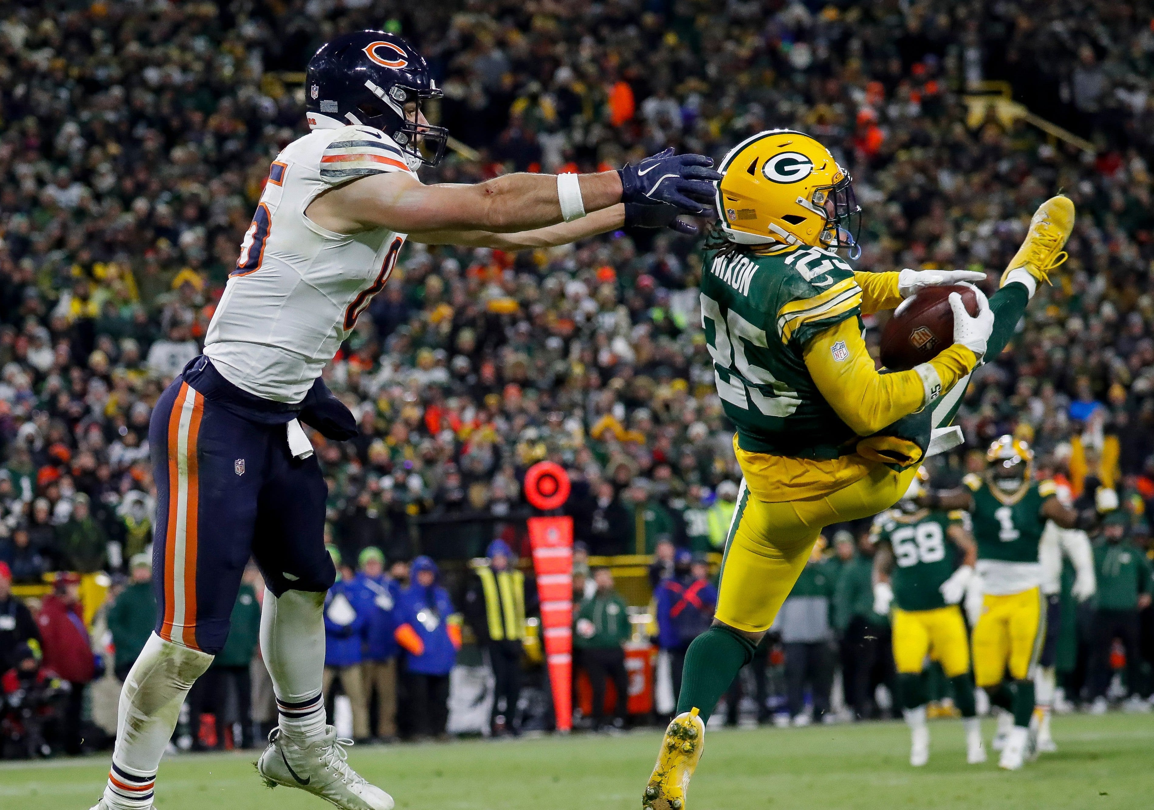 Green Bay Packers cornerback Keisean Nixon (25) intercepts a pass intended for Chicago Bears tight end Cole Kmet (85) in the end zone to seal a victory on Sunday, December 7, 2025, at Lambeau Field in Green Bay, Wis.