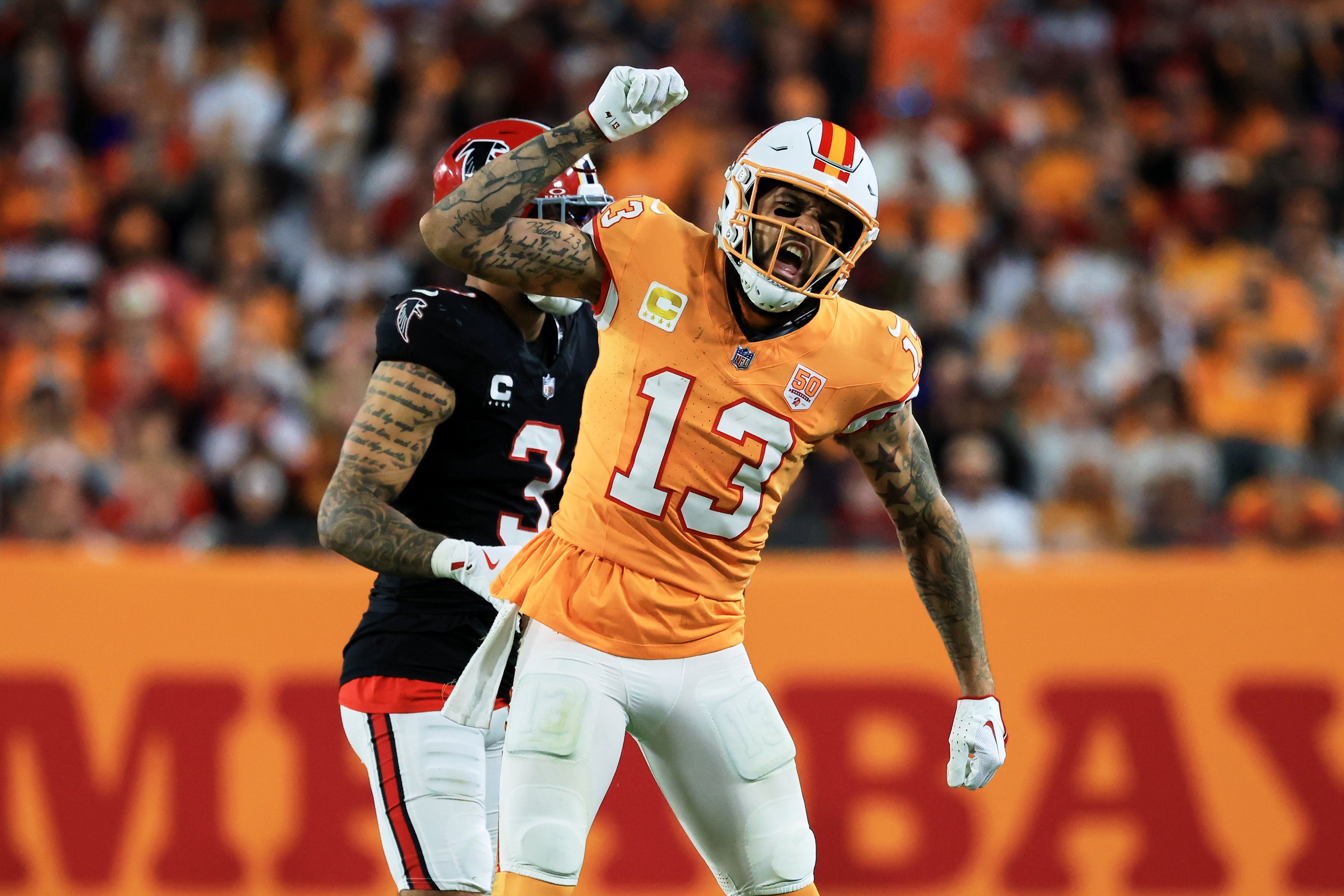 Dec 11, 2025; Tampa, Florida, USA; Tampa Bay Buccaneers wide receiver Mike Evans (13) reacts after catching a pass against Atlanta Falcons safety Jessie Bates III (3) (obscured) during the third quarter at Raymond James Stadium.