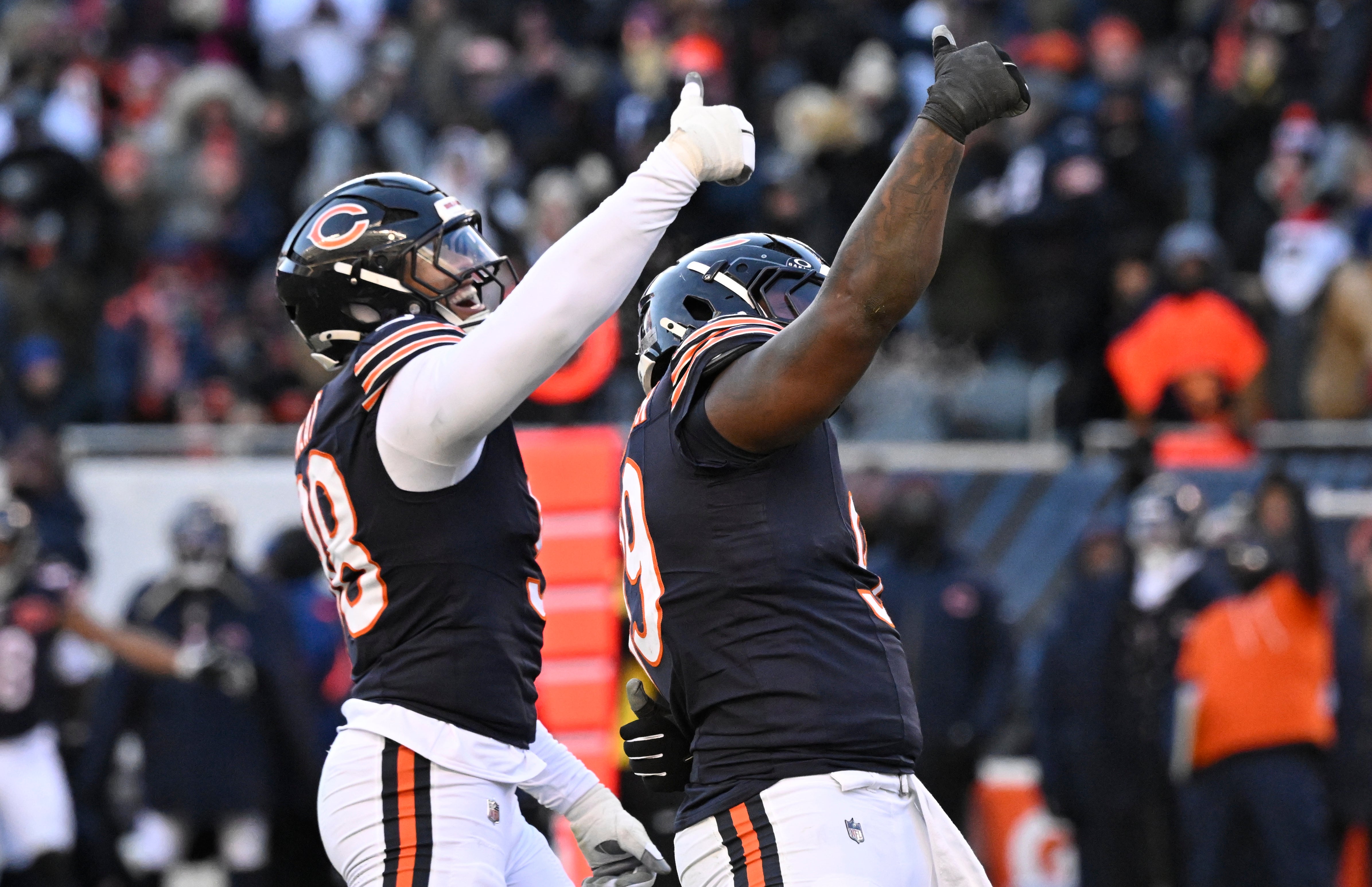 Dec 14, 2025; Chicago, Illinois, USA; Chicago Bears defensive end Montez Sweat (98) and Chicago Bears defensive tackle Gervon Dexter Sr. (99) celebrate after a sack of Cleveland Browns quarterback Shedeur Sanders (12) during the fourth quarter at Soldier Field.