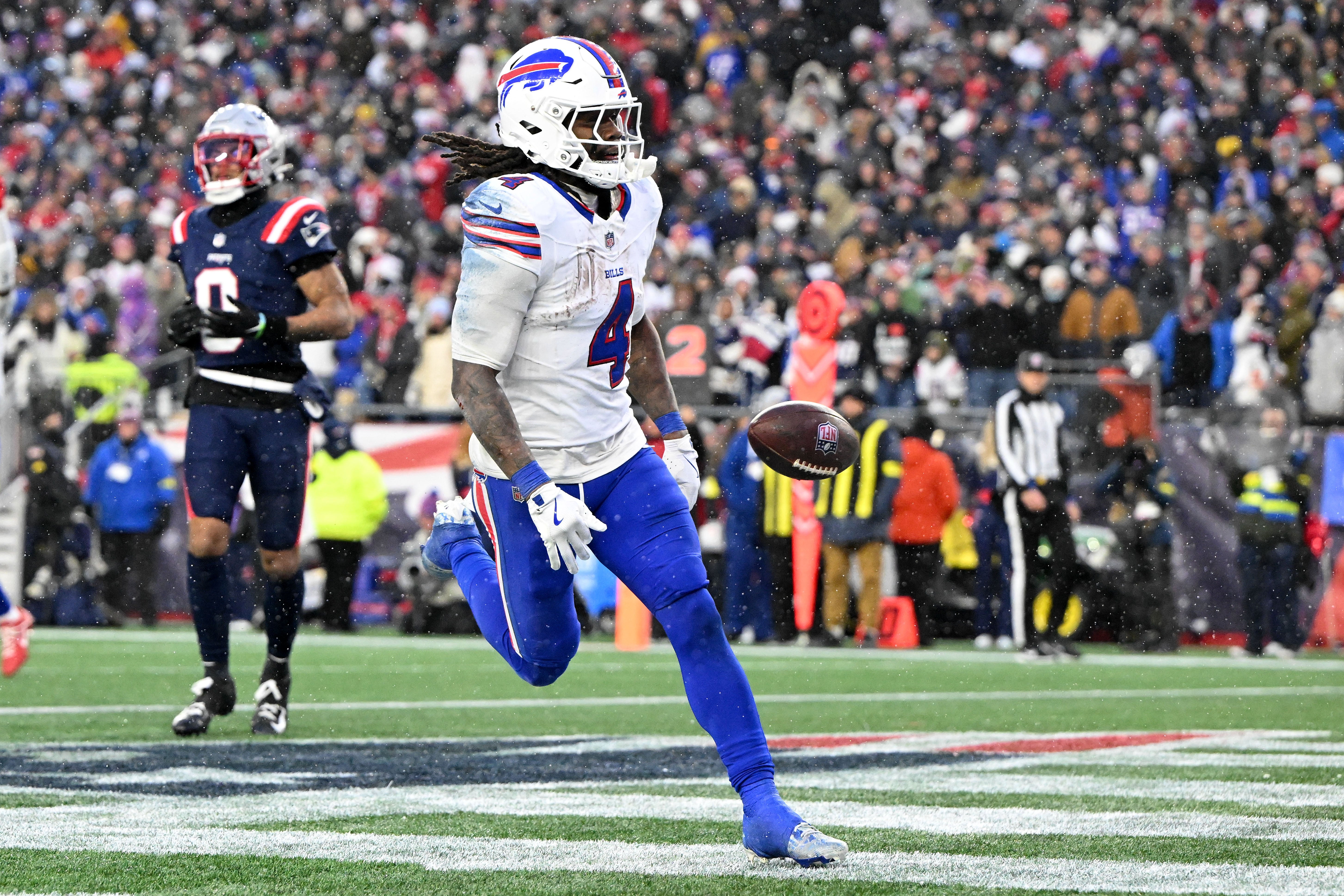 Dec 14, 2025; Foxborough, Massachusetts, USA; Buffalo Bills running back James Cook III (4) runs for a touchdown against the New England Patriots during the second half at Gillette Stadium.