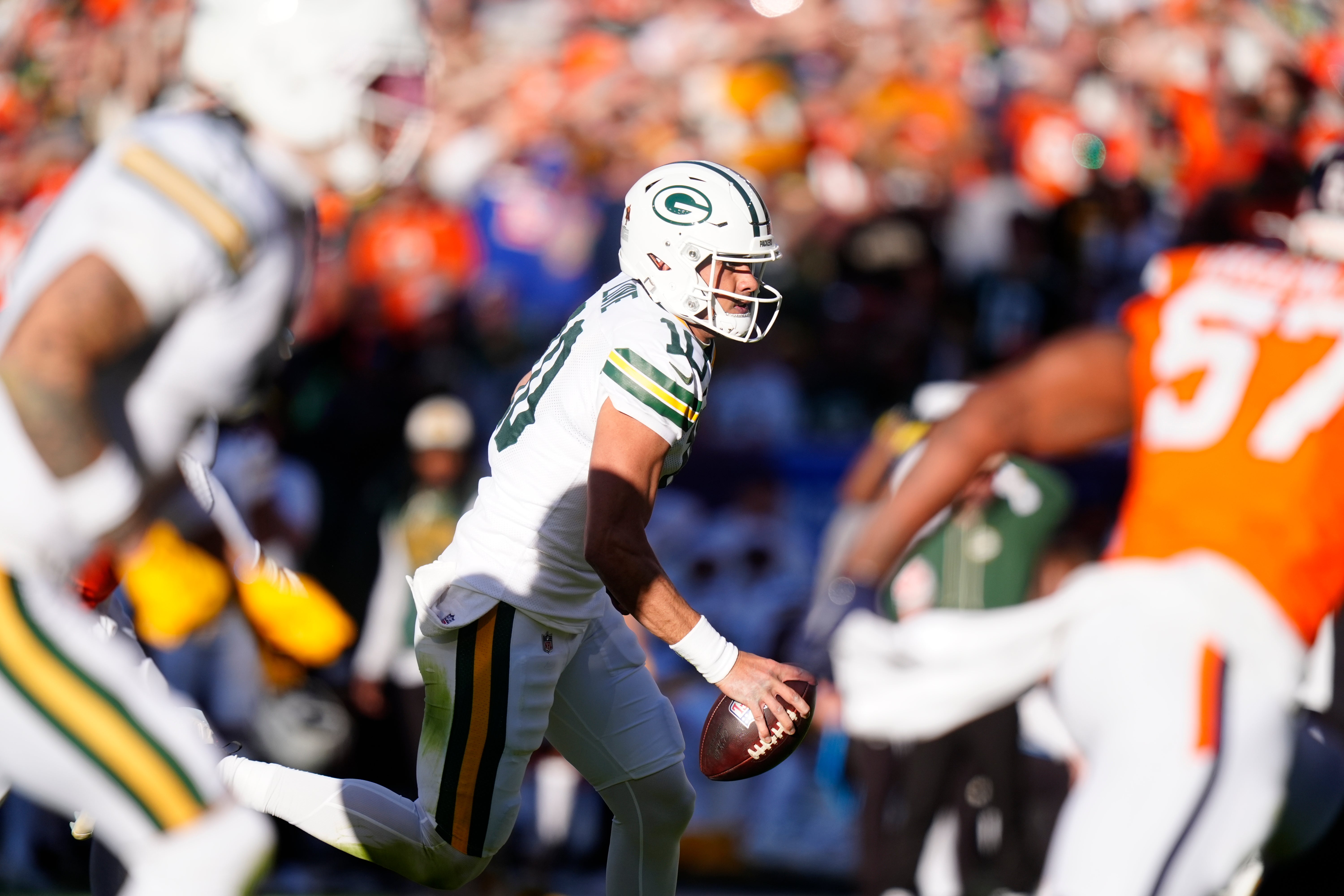 Dec 14, 2025; Denver, Colorado, USA; Green Bay Packers quarterback Jordan Love (10) runs for a gain during the first quarter against the Denver Broncos at Empower Field at Mile High.