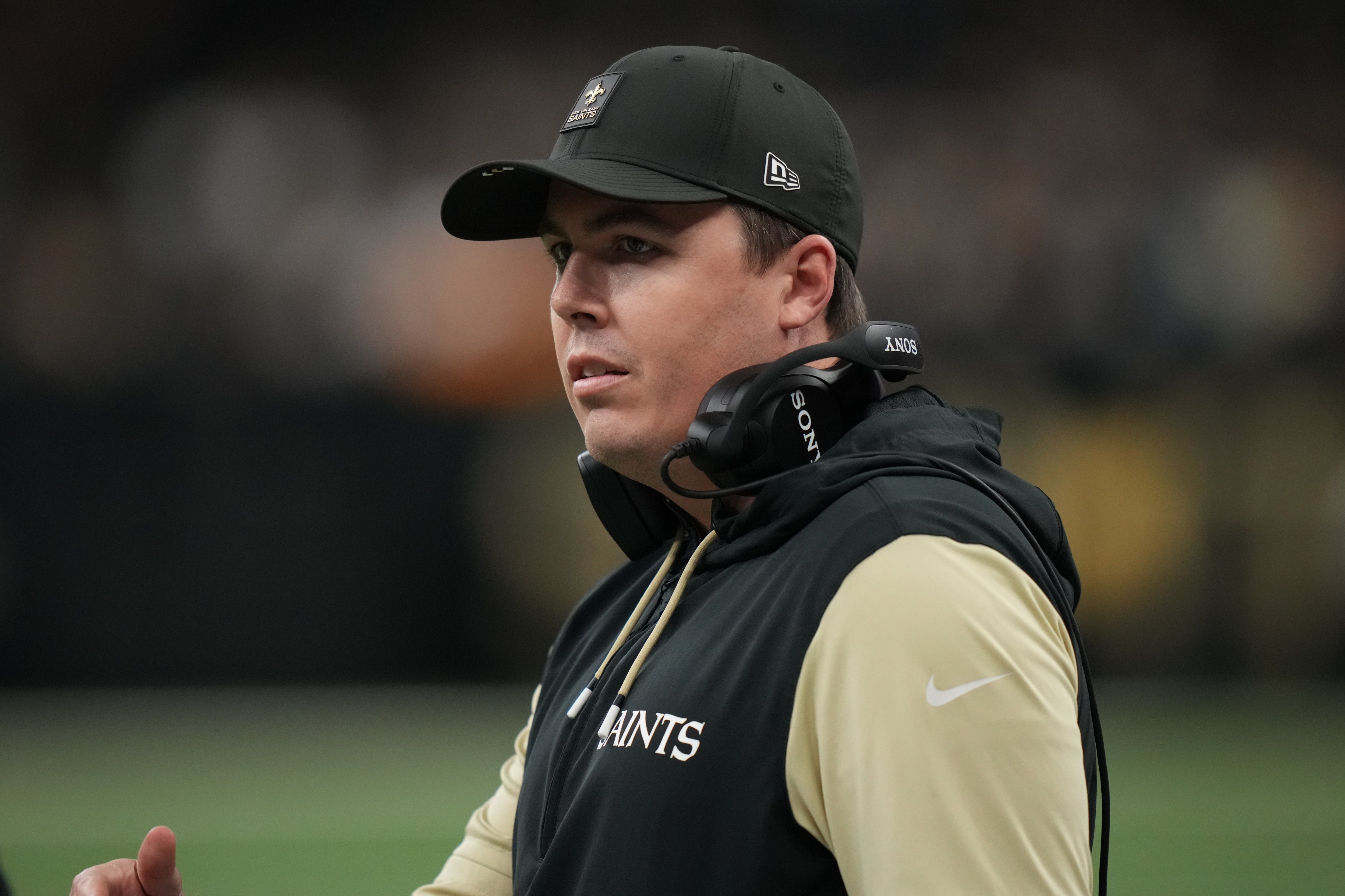 Dec 14, 2025; New Orleans, Louisiana, USA; New Orleans Saints head coach Kellen Moore speaks with a referee during the first quarter against the Carolina Panthers at Caesars Superdome.