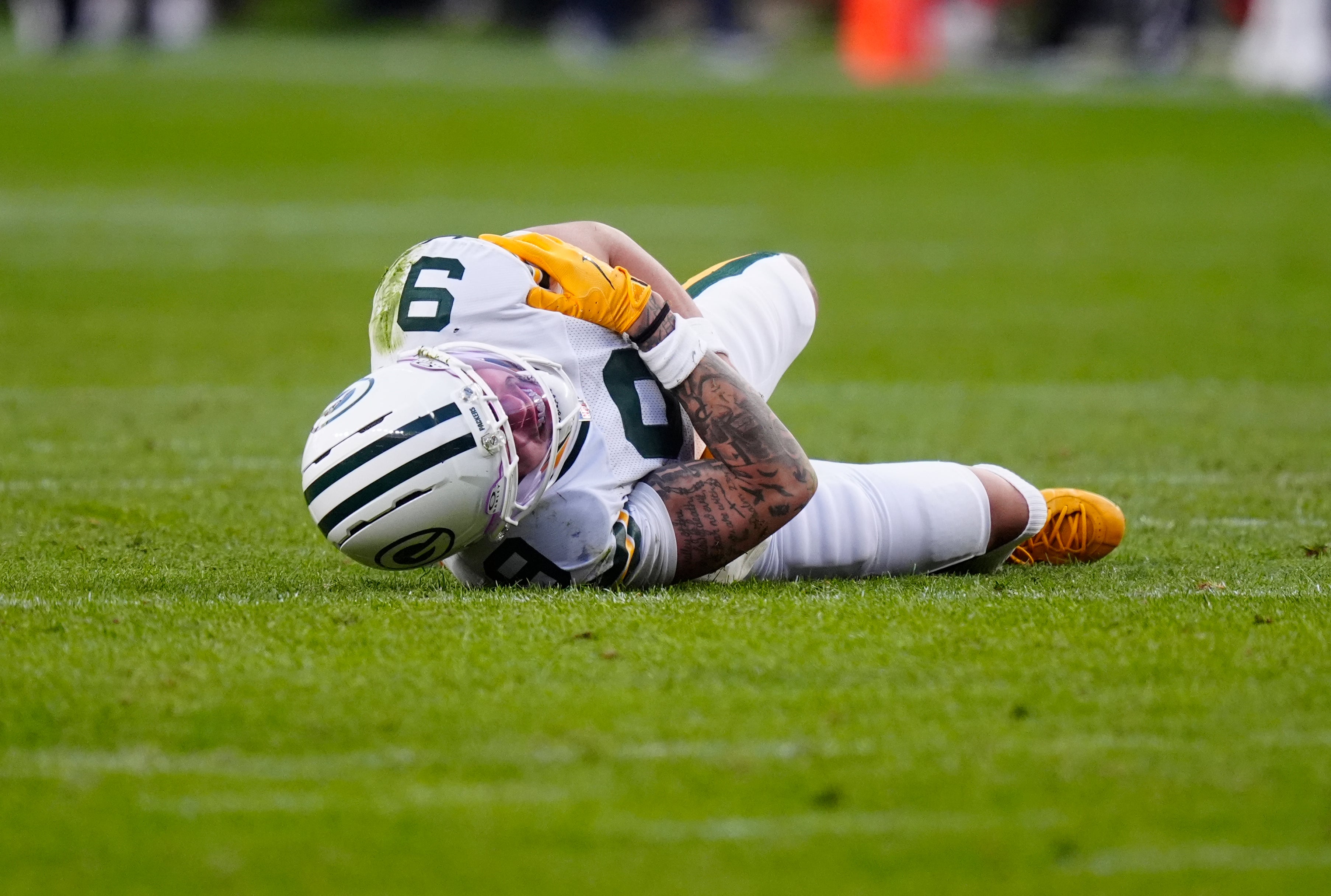 Dec 14, 2025; Denver, Colorado, USA; Green Bay Packers wide receiver Christian Watson (9) lies on the field following an injury during the third quarter against the Denver Broncos at Empower Field at Mile High.