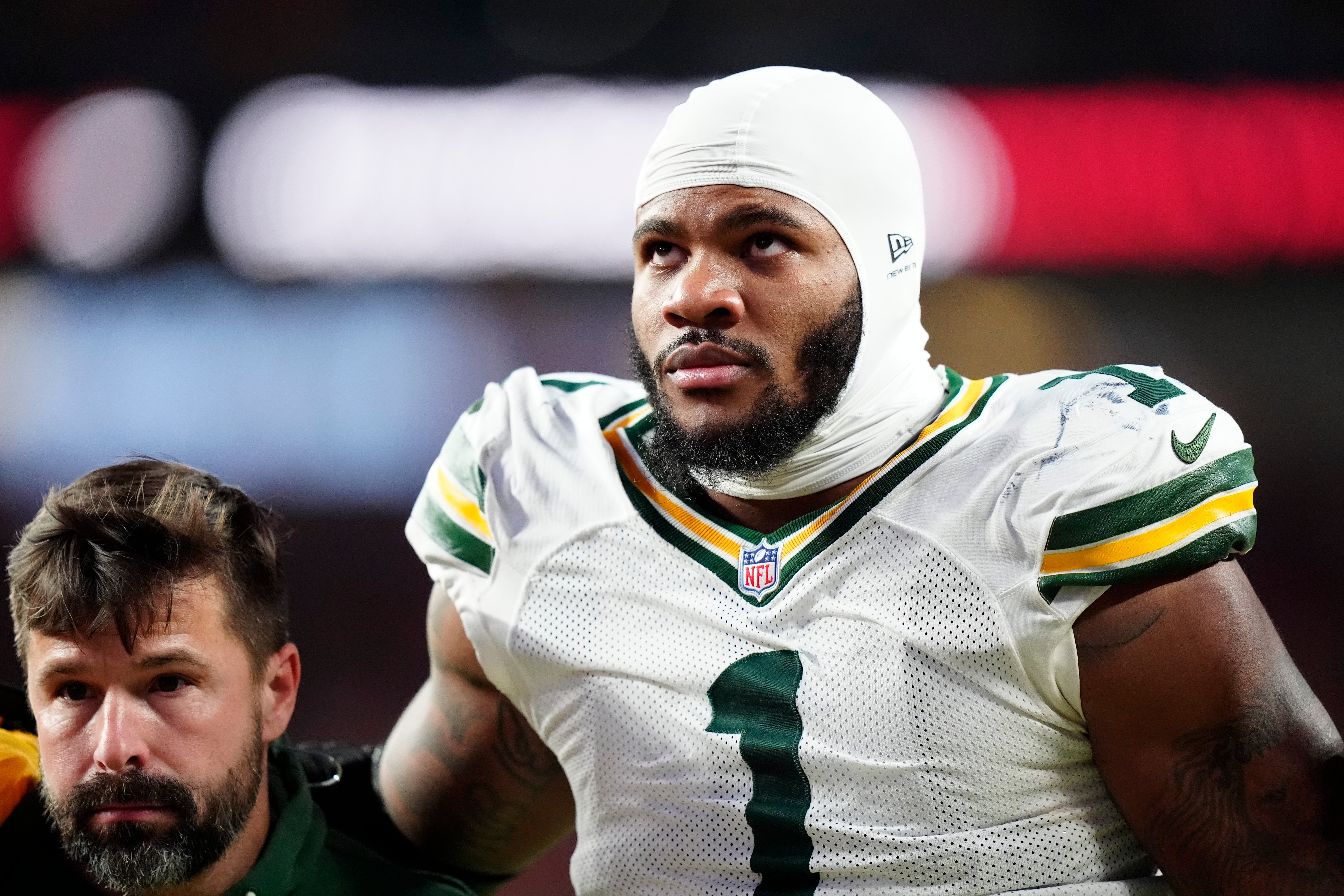 Dec 14, 2025; Denver, Colorado, USA; Green Bay Packers defensive end Micah Parsons (1) walks off the field with help from medical personnel following an injury during the third quarter against the Denver Broncos at Empower Field at Mile High.