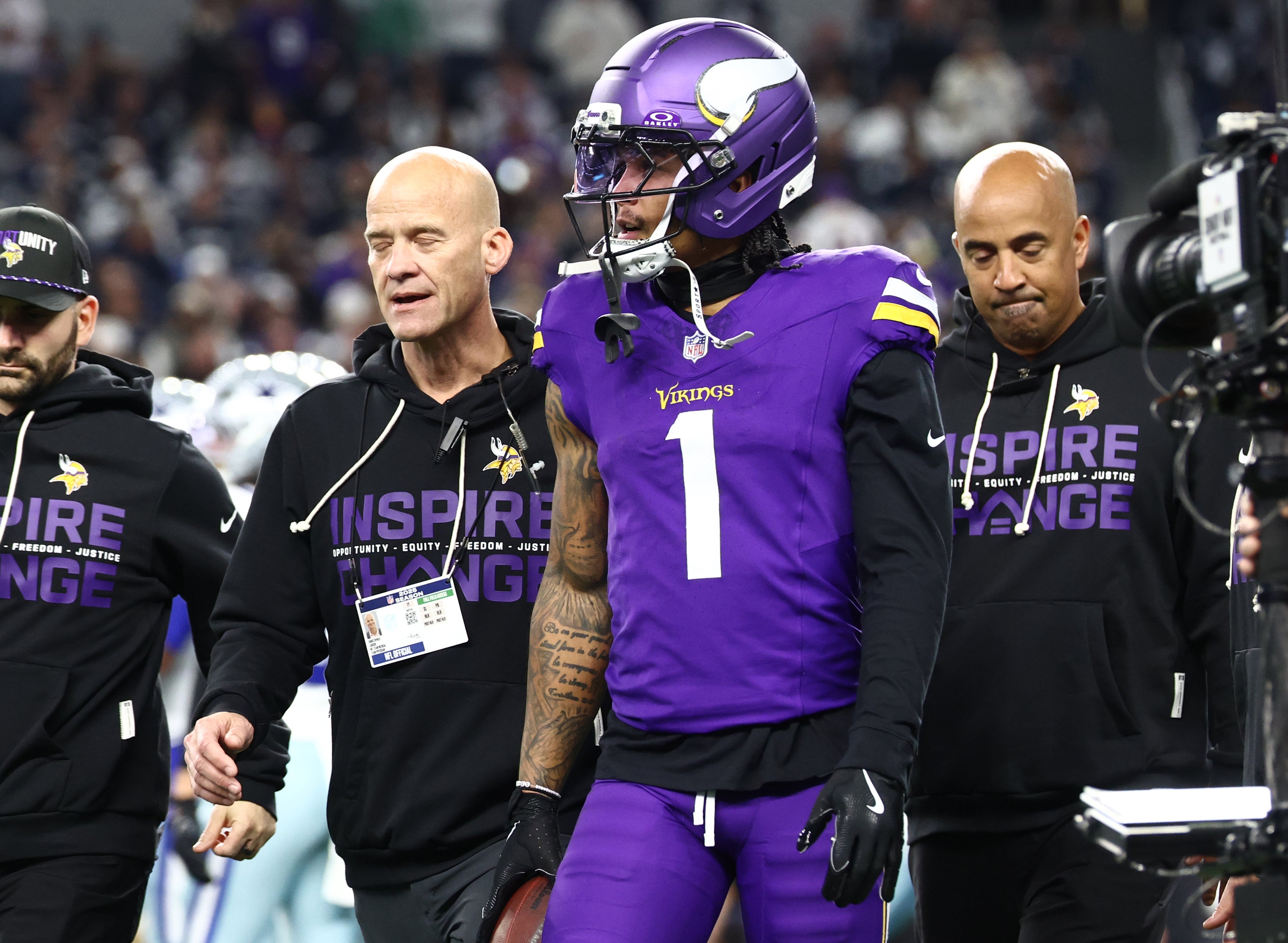 Dec 14, 2025; Arlington, Texas, USA; Minnesota Vikings wide receiver Jalen Nailor (1) is helped off the field by trainers after a touchdown during the first half against the Dallas Cowboys at AT&T Stadium.