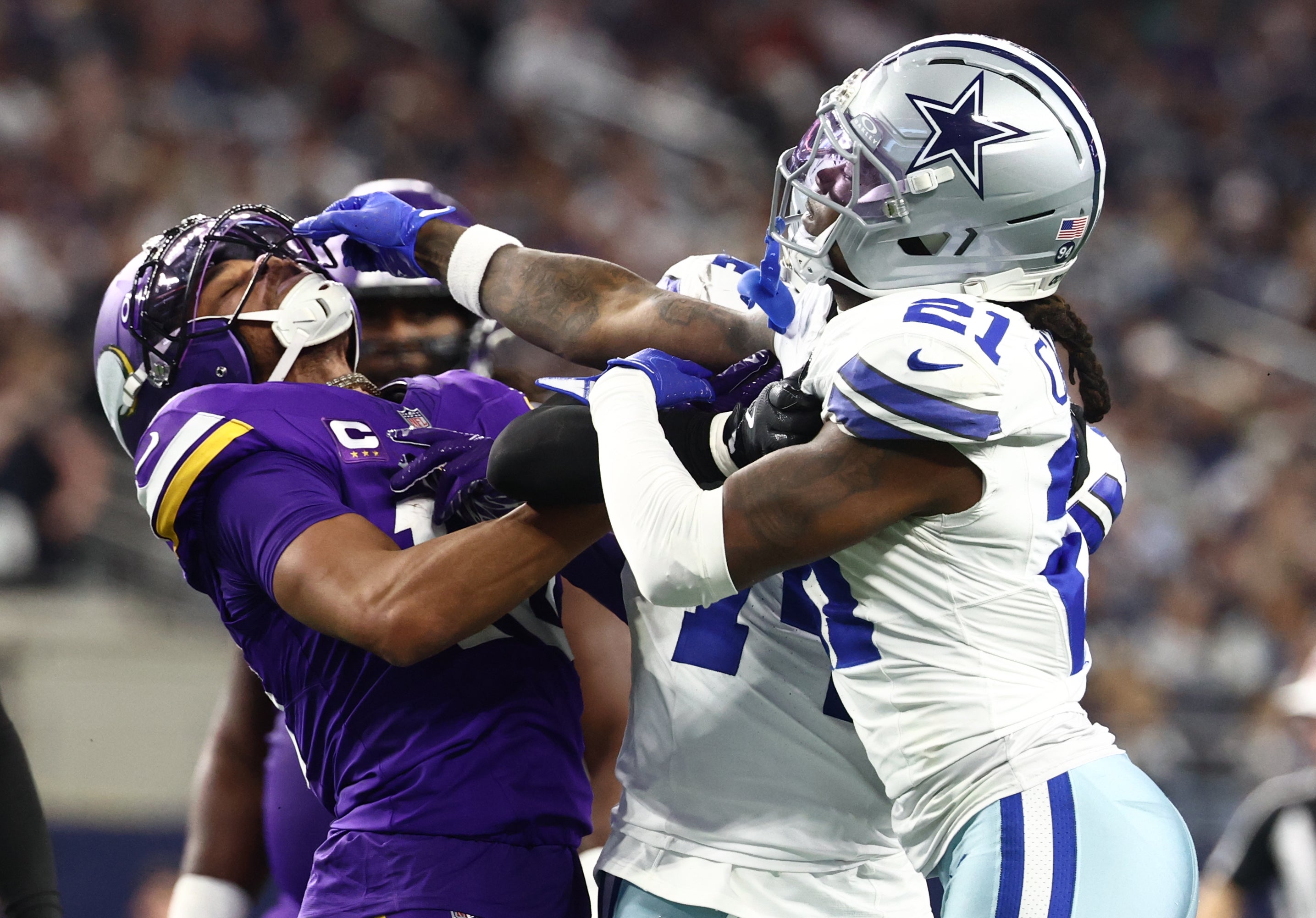 Dec 14, 2025; Arlington, Texas, USA; Minnesota Vikings wide receiver Justin Jefferson (18) and Dallas Cowboys cornerback Caelen Carson (21) battle during the first half at AT&T Stadium.