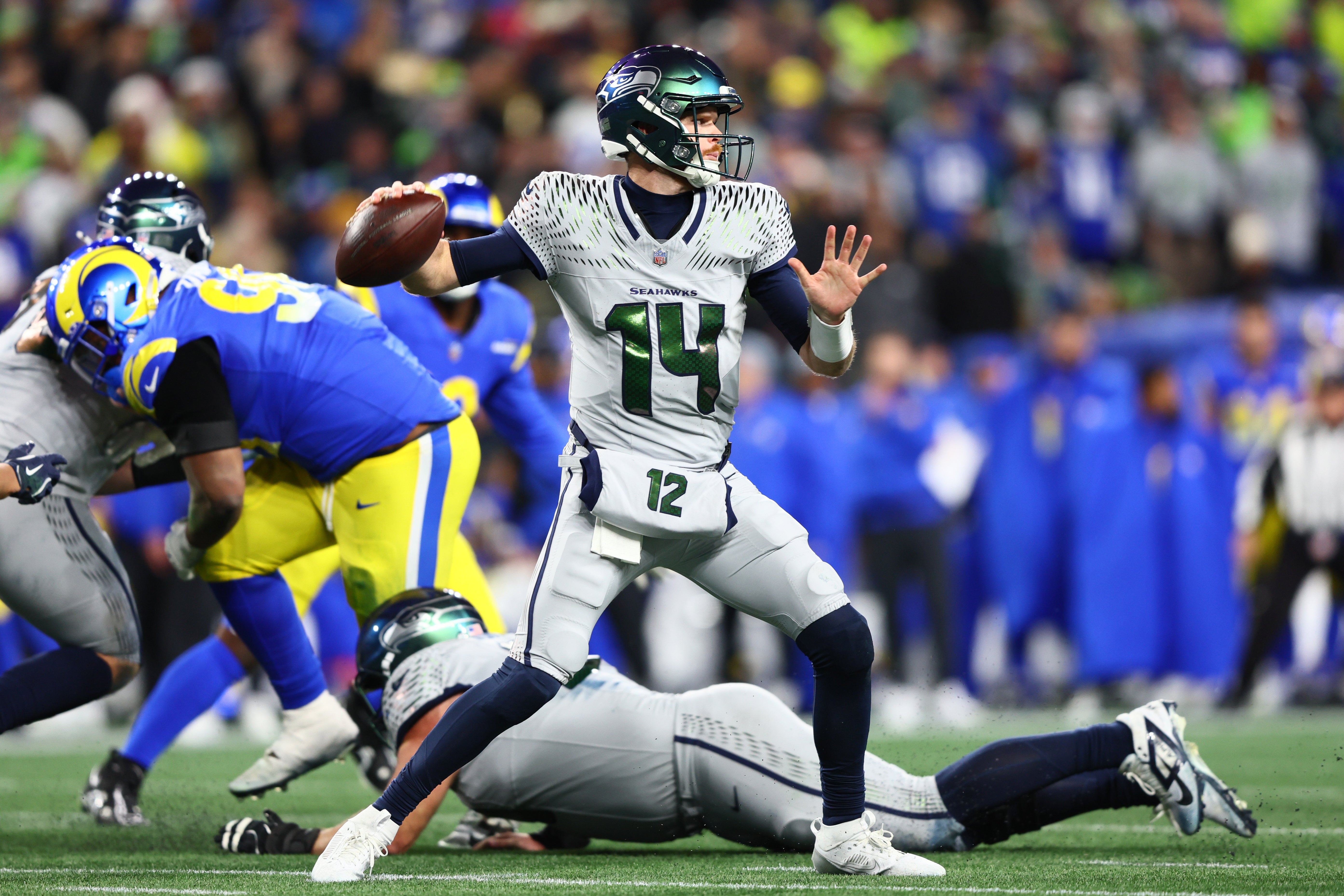 Dec 18, 2025; Seattle, Washington, USA; Seattle Seahawks quarterback Sam Darnold (14) throws a pass against the Los Angeles Rams in the second half at Lumen Field.