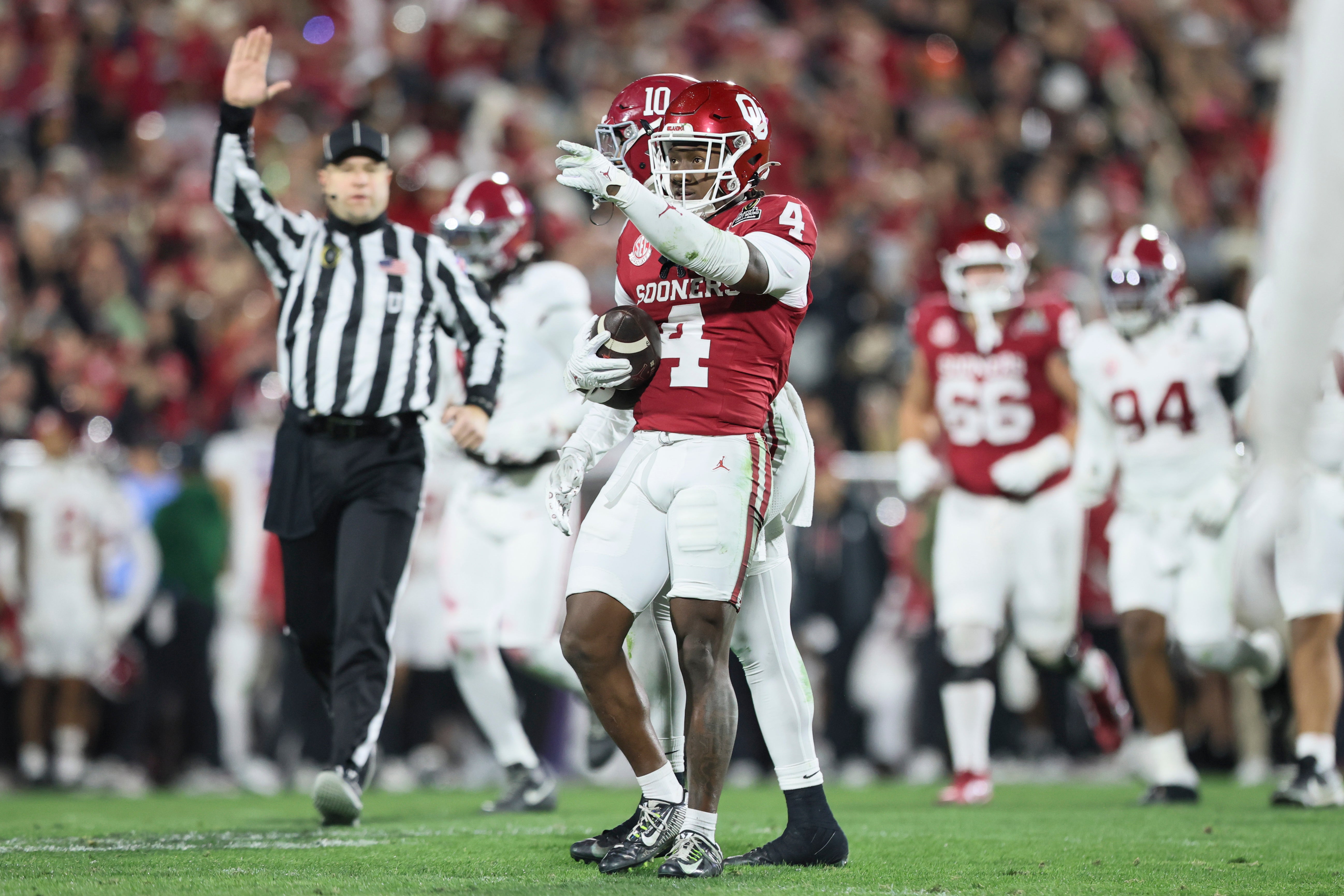 Dec 19, 2025; Norman, OK, USA; Oklahoma Sooners wide receiver Deion Burks (4) gestures in the first half against the Alabama Crimson Tide at Gaylord Family OK Memorial Stadium.