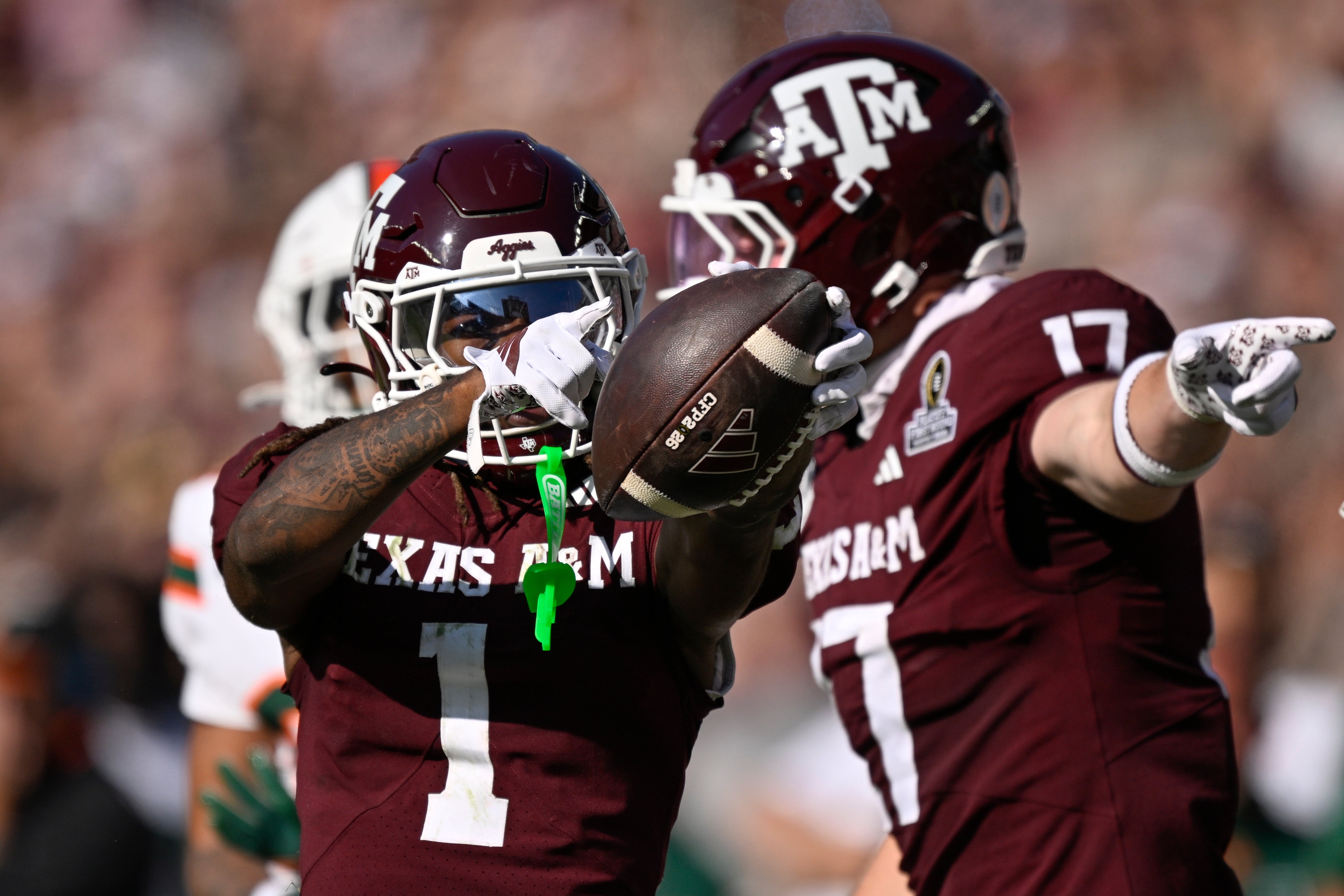 Dec 20, 2025; College Station, TX, USA; Texas A&M Aggies wide receiver Mario Craver (1) and Texas A&M Aggies tight end Theo Melin Öhrström (17) celebrate a first down against the Miami Hurricanes during the second half of the first round game of the CFP National Playoff at Kyle Field.