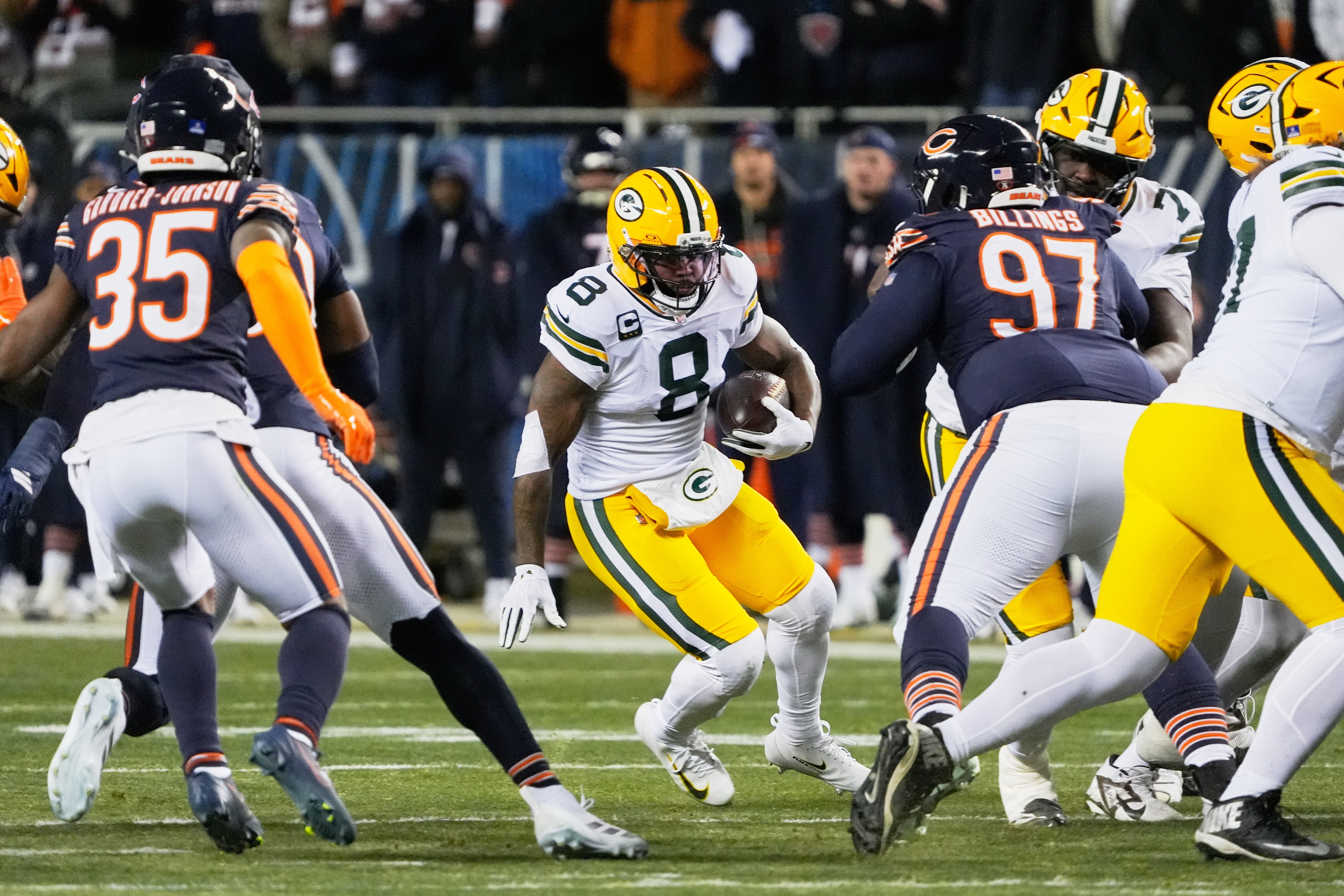Dec 20, 2025; Chicago, Illinois, USA; Green Bay Packers running back Josh Jacobs (8) runs the ball against Chicago Bears defensive tackle Andrew Billings (97) and safety C.J. Gardner-Johnson (35) during the first quarter at Soldier Field.