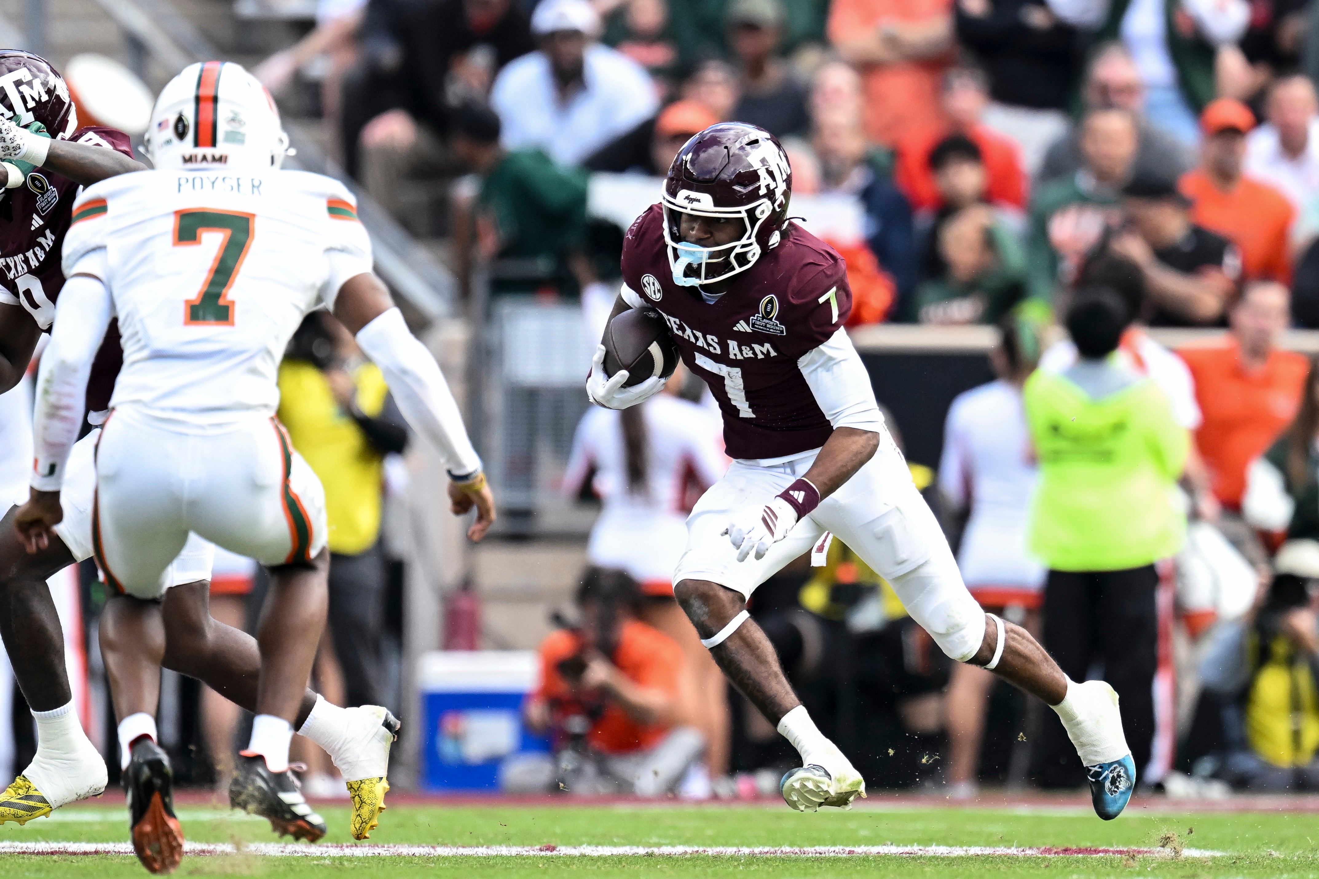 Dec 20, 2025; College Station, TX, USA; Texas A&M Aggies wide receiver KC Concepcion (7) runs the ball against the Miami Hurricanes during the second half at Kyle Field.