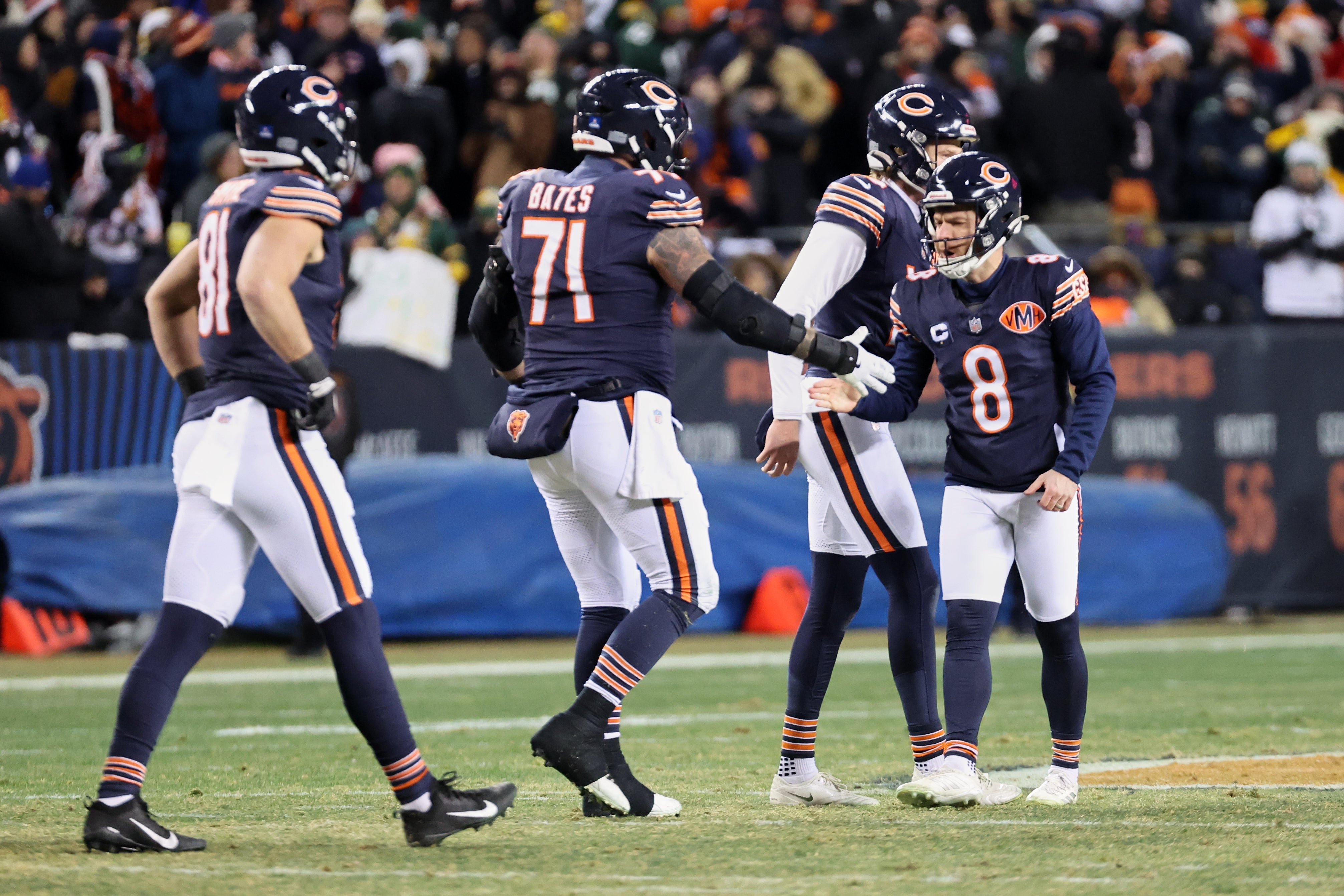 Dec 20, 2025; Chicago, Illinois, USA; Chicago Bears placekicker Cairo Santos (8) shakes hands with center Ryan Bates (71) after kicking the game-tying extra point against the Green Bay Packers with twenty-four seconds remaining in the fourth quarter at Soldier Field.