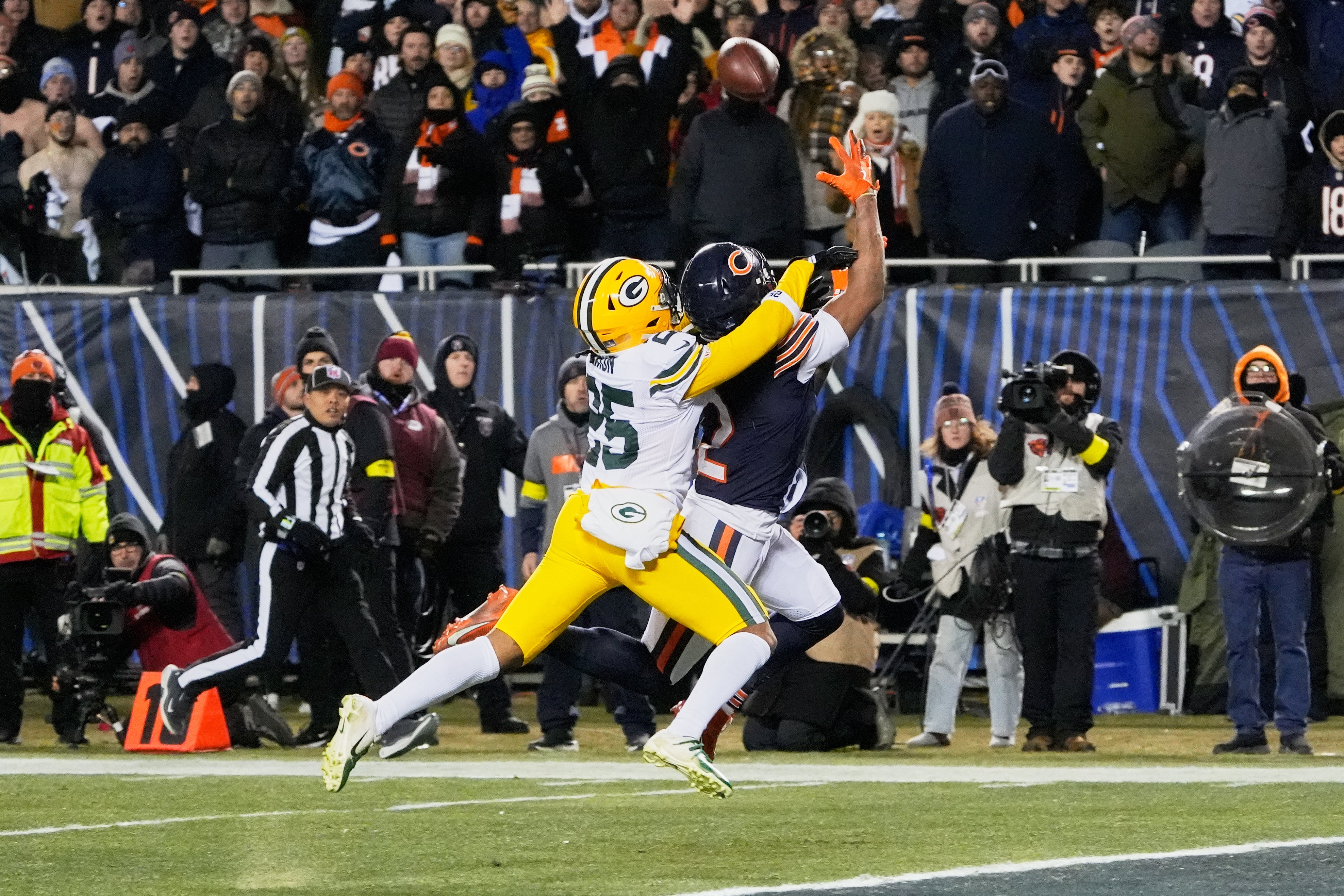 Dec 20, 2025; Chicago, Illinois, USA; Chicago Bears wide receiver DJ Moore (2) catches the game-winning forty-six yard touchdown pass thrown by quarterback Caleb Williams (not pictured) against Green Bay Packers cornerback Keisean Nixon (25) in overtime at Soldier Field.