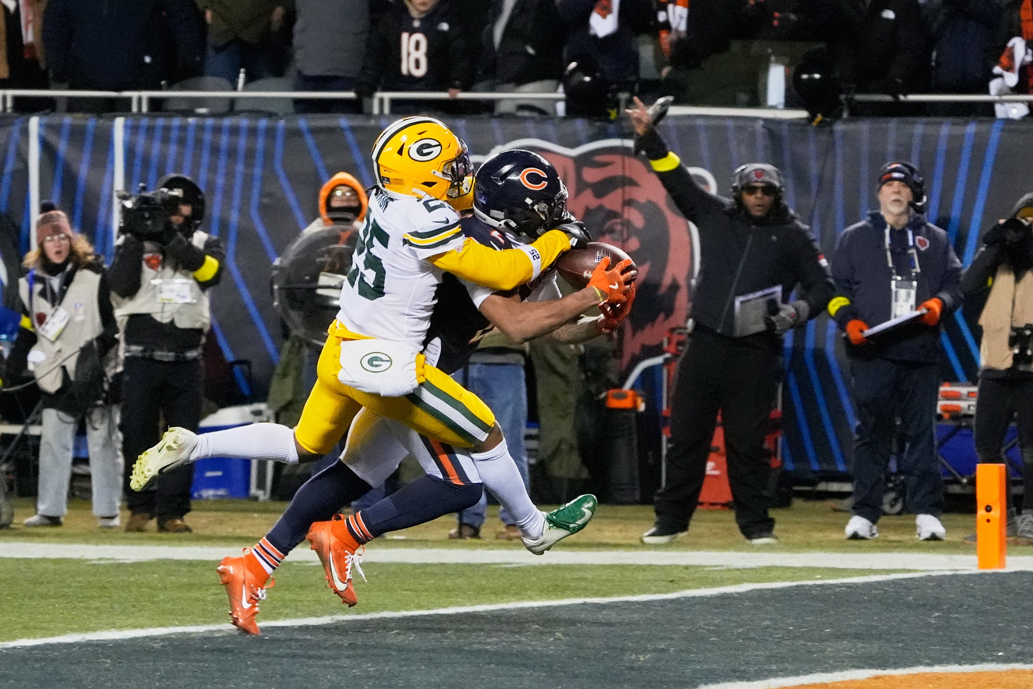Dec 20, 2025; Chicago, Illinois, USA; Chicago Bears wide receiver DJ Moore (2) catches the game-winning forty-six yard touchdown pass thrown by quarterback Caleb Williams (not pictured) against Green Bay Packers cornerback Keisean Nixon (25) in overtime at Soldier Field.