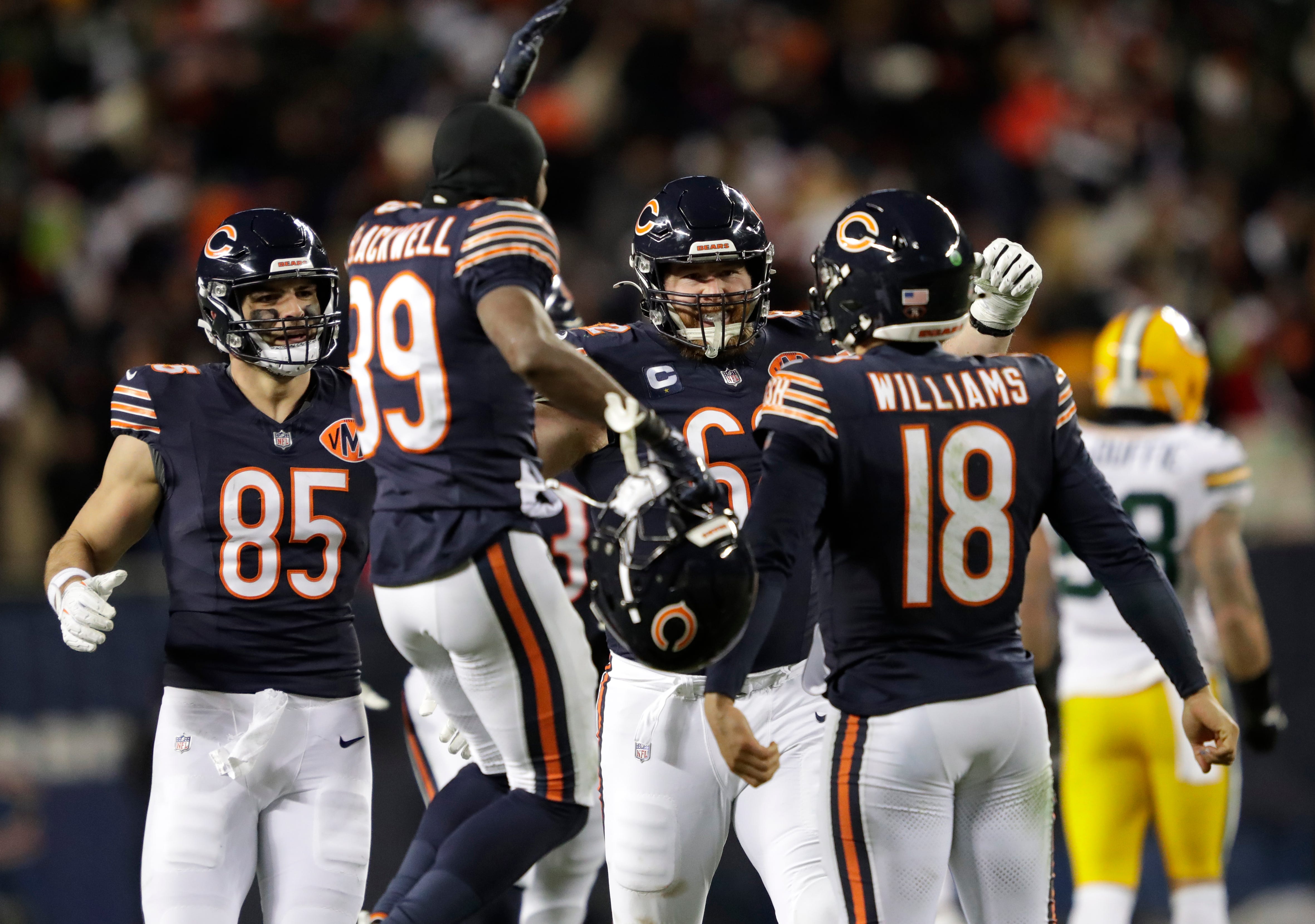 Chicago Bears quarterback Caleb Williams (18) is swarmed by teammates after throwing the game-winning touchdown pass in overtime against the Green Bay Packers during their football game Saturday, December 20, 2025, at Soldier Field in Chicago, Illinois.