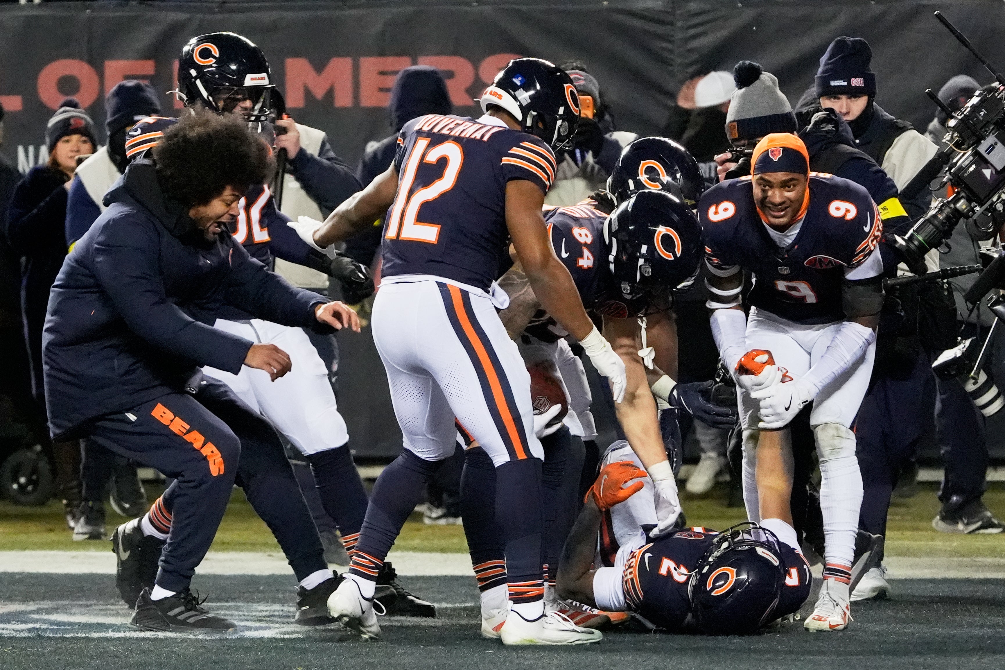 Dec 20, 2025; Chicago, Illinois, USA; Chicago Bears wide receiver DJ Moore (2) celebrates with teammates in the end zone after scoring the game-winning touchdown in overtime against the Green Bay Packers at Soldier Field.