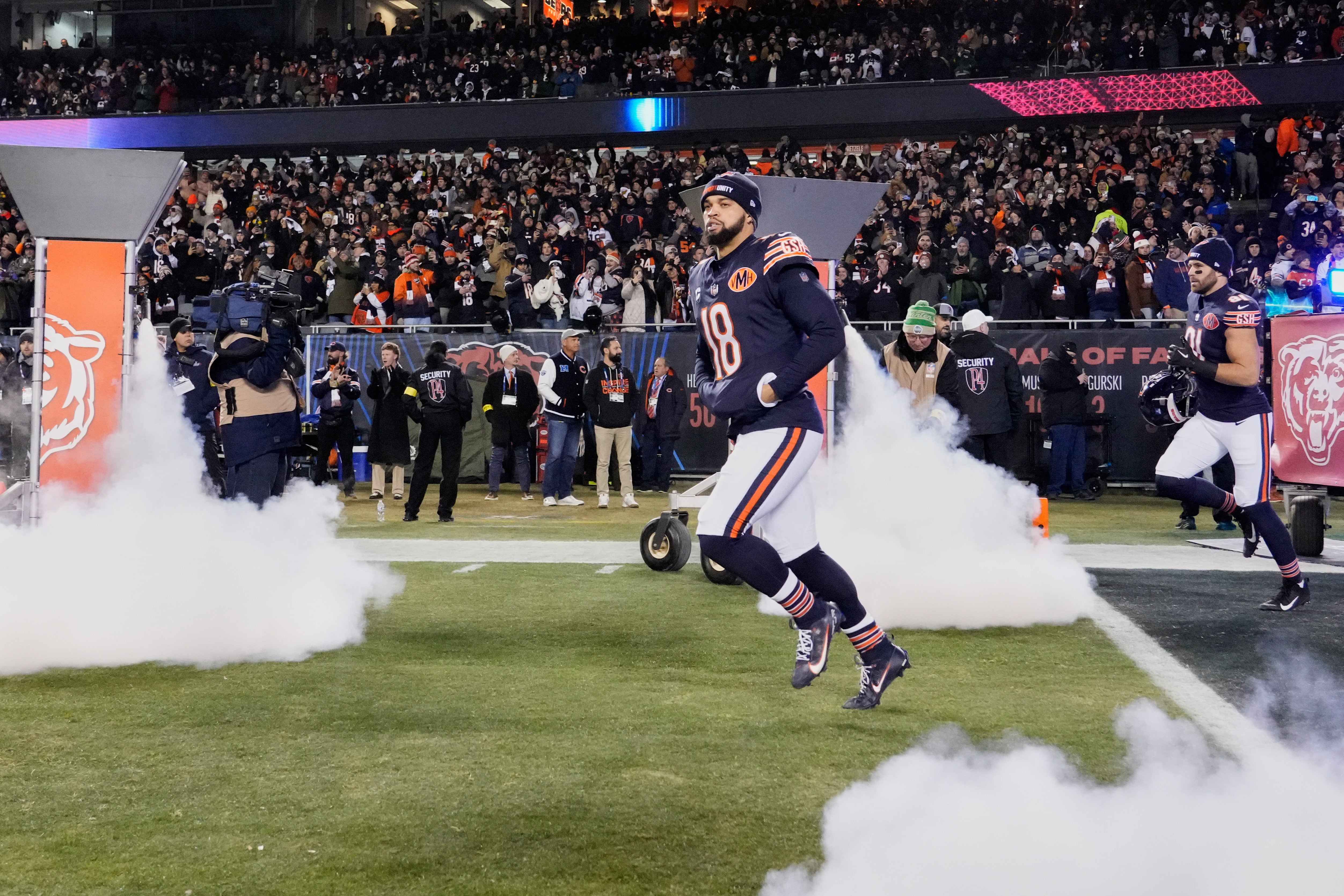 Dec 20, 2025; Chicago, Illinois, USA; Chicago Bears quarterback Caleb Williams (18) runs onto the field during player introductions before the game against the Green Bay Packers at Soldier Field.