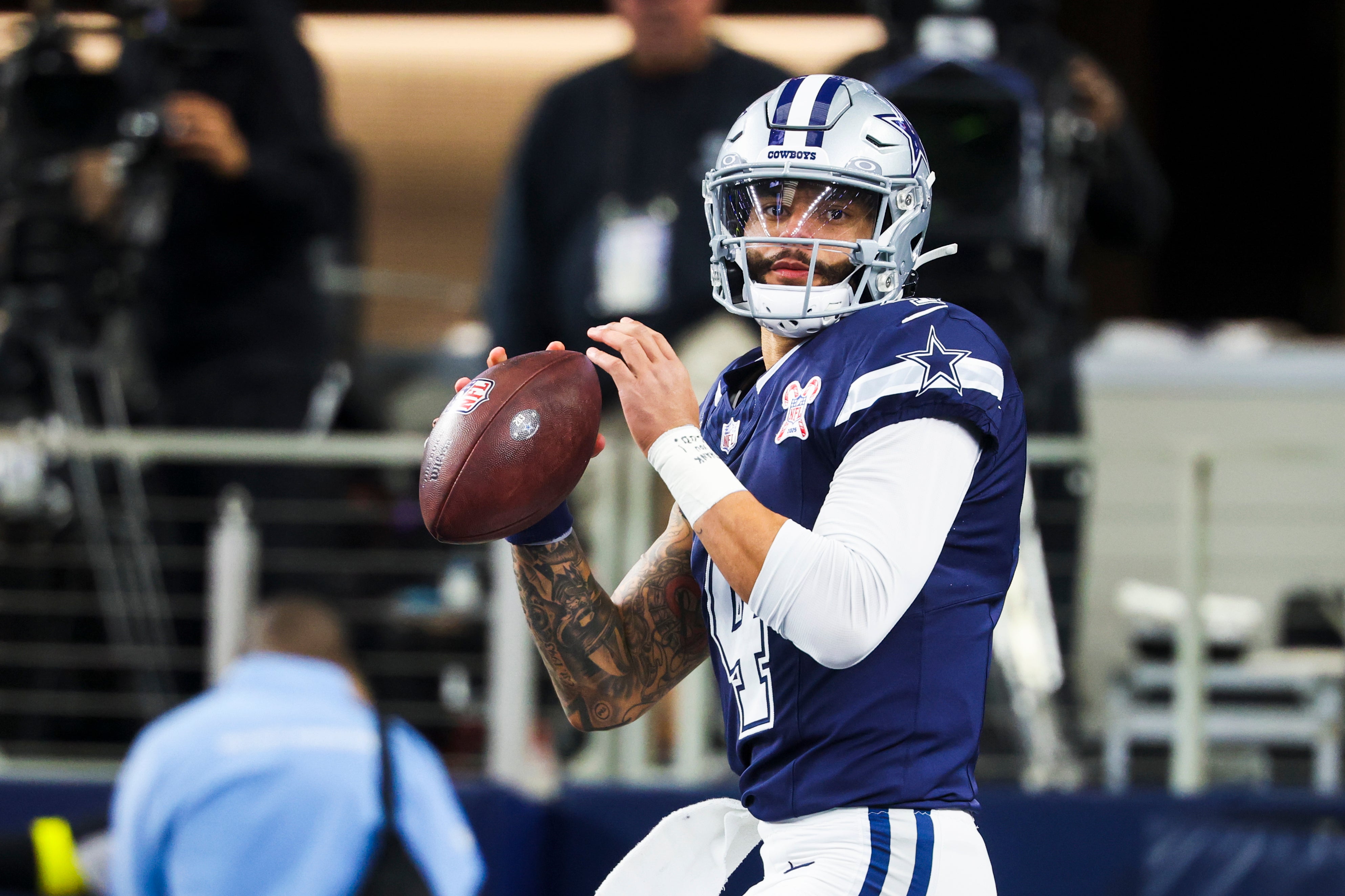 Dec 21, 2025; Arlington, Texas, USA; Dallas Cowboys quarterback Dak Prescott (4) participates in pregame warmups against the Los Angeles Chargers at AT&T Stadium.