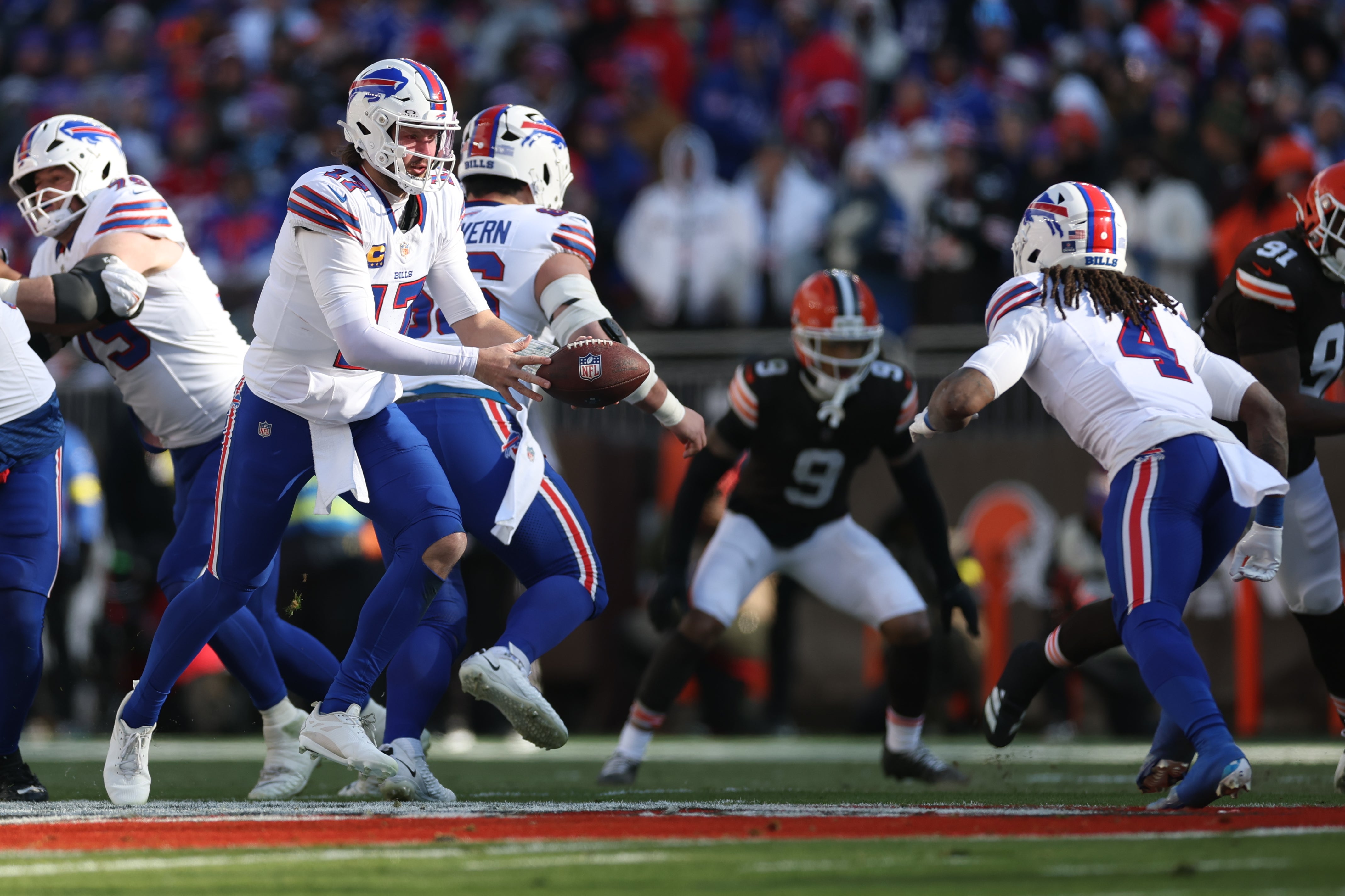 Dec 21, 2025; Cleveland, Ohio, USA; Buffalo Bills quarterback Josh Allen (17) prepares to hand the ball off to running back James Cook III (4) during the first half against the Cleveland Browns at Huntington Bank Field.