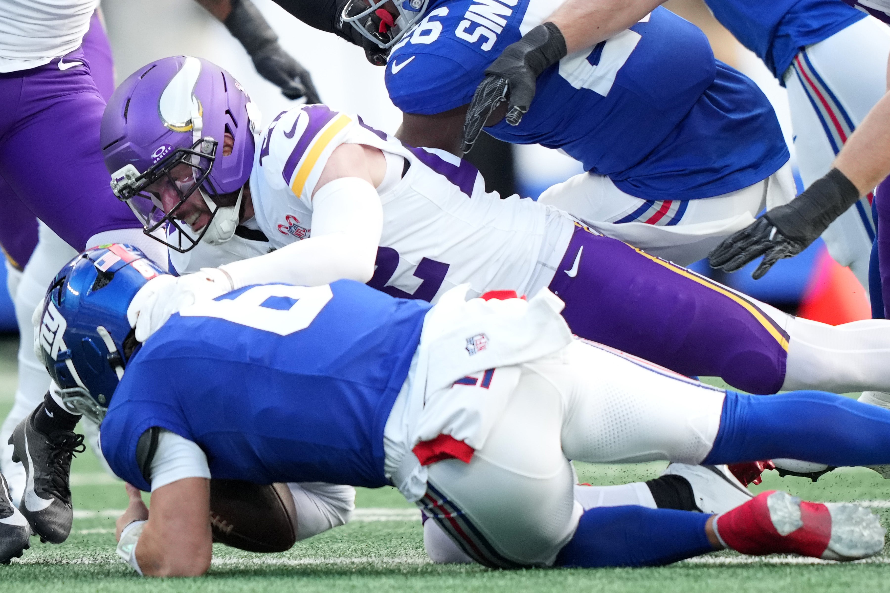Dec 21, 2025; East Rutherford, New Jersey, USA; Minnesota Vikings free safety Harrison Smith (22) sacks New York Giants quarterback Jaxson Dart (6) during the first half at MetLife Stadium.