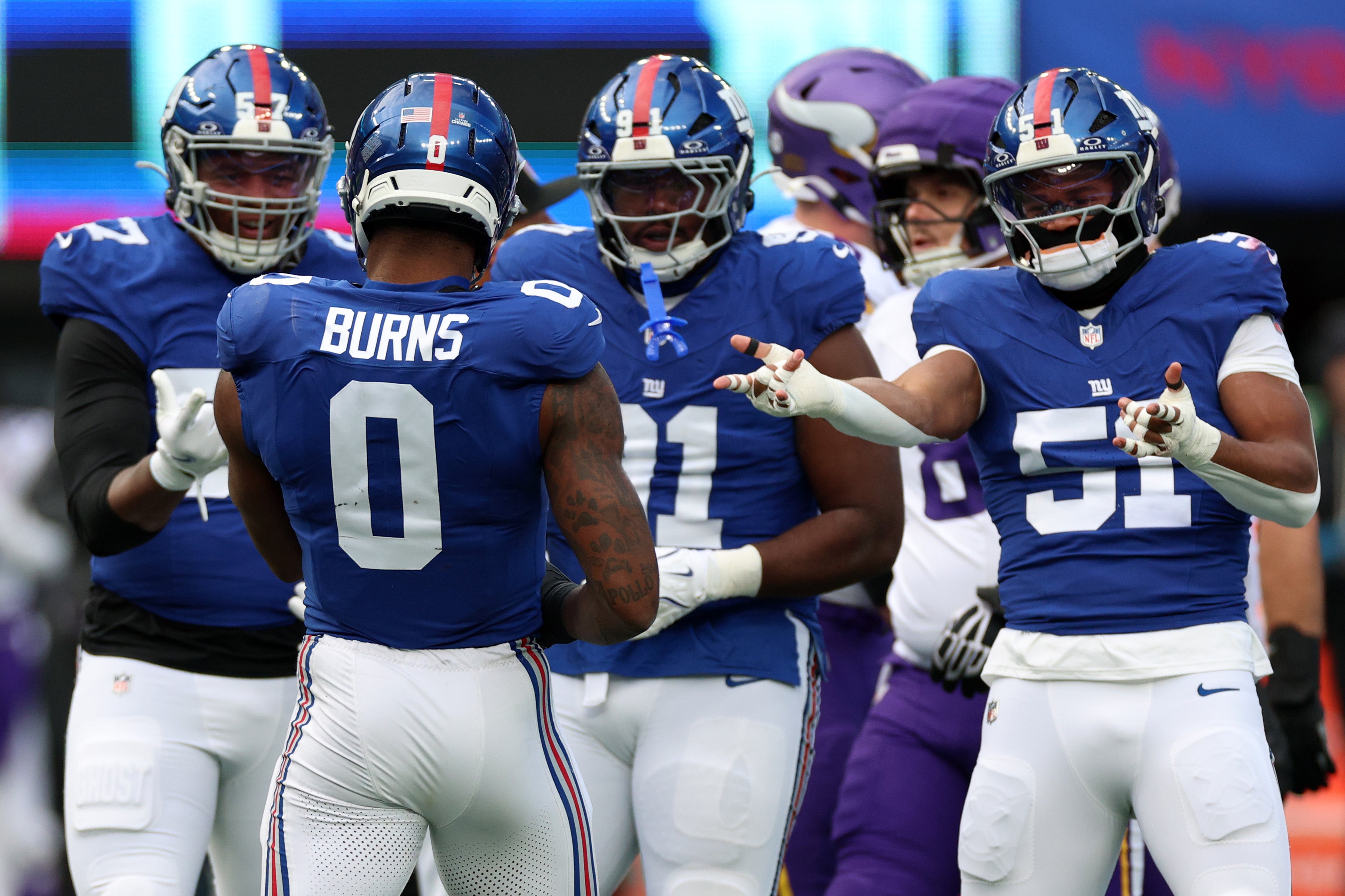 Dec 21, 2025; East Rutherford, New Jersey, USA; New York Giants linebacker Brian Burns (0) reacts with teammates against the Minnesota Vikings during the first half at MetLife Stadium.