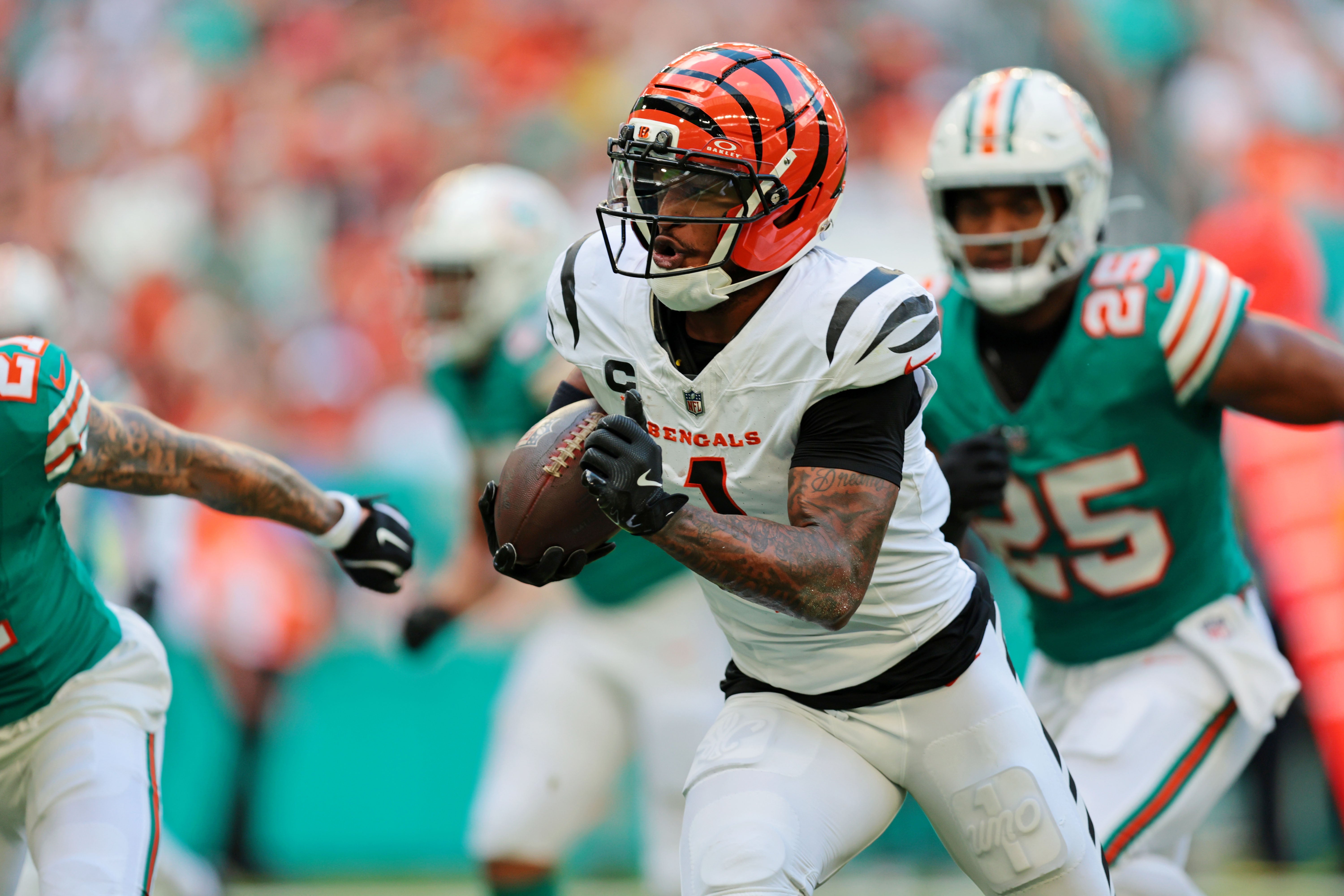 Dec 21, 2025; Miami Gardens, Florida, USA; Cincinnati Bengals wide receiver Ja'Marr Chase (1) runs the ball during the first quarter against the Miami Dolphins at Hard Rock Stadium.