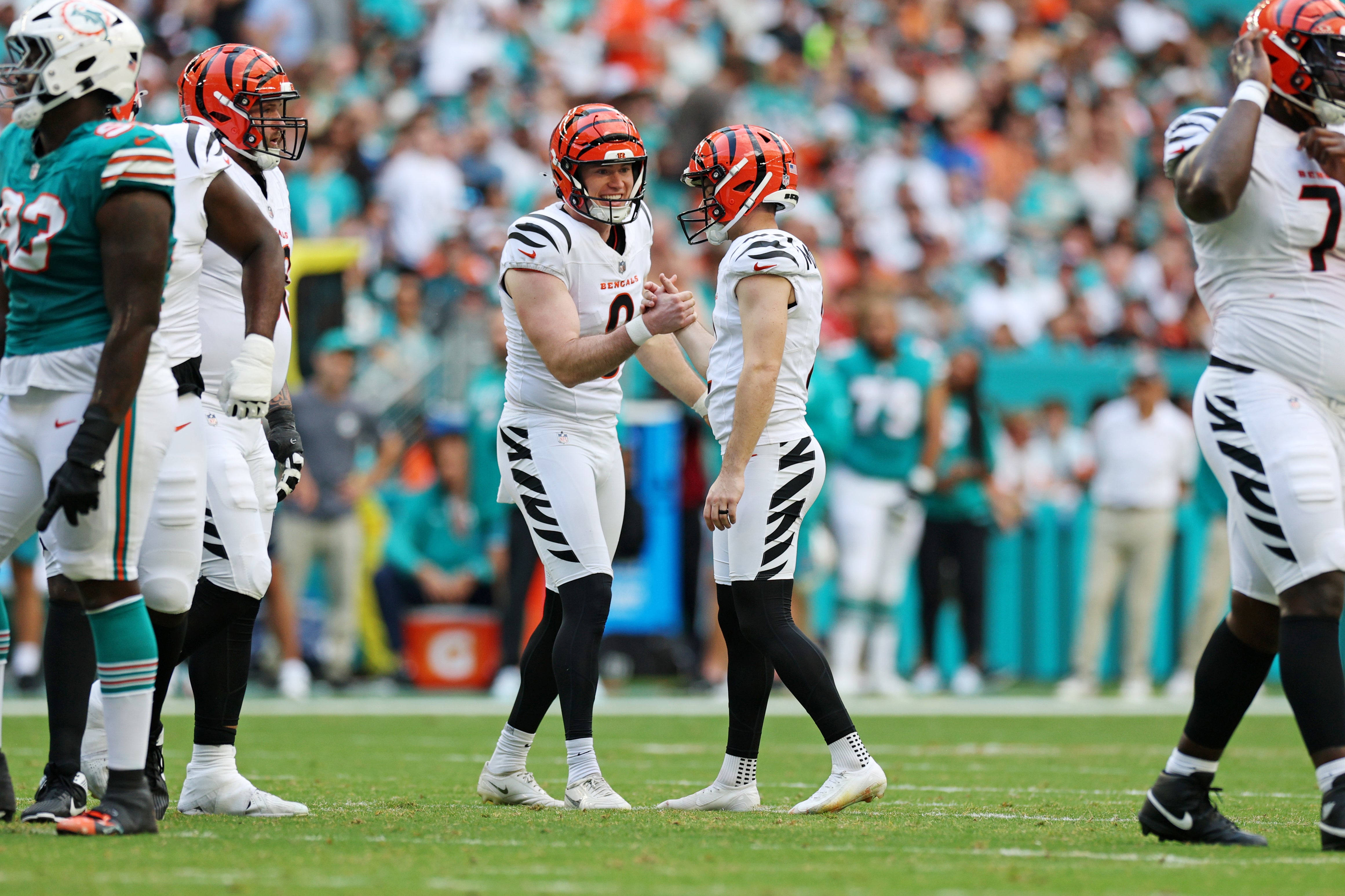Dec 21, 2025; Miami Gardens, Florida, USA; Cincinnati Bengals place kicker Evan McPherson (2) and Cincinnati Bengals punter Ryan Rehkow (8) celebrate after a field goal during the second quarter nagainst the Miami Dolphins at Hard Rock Stadium.