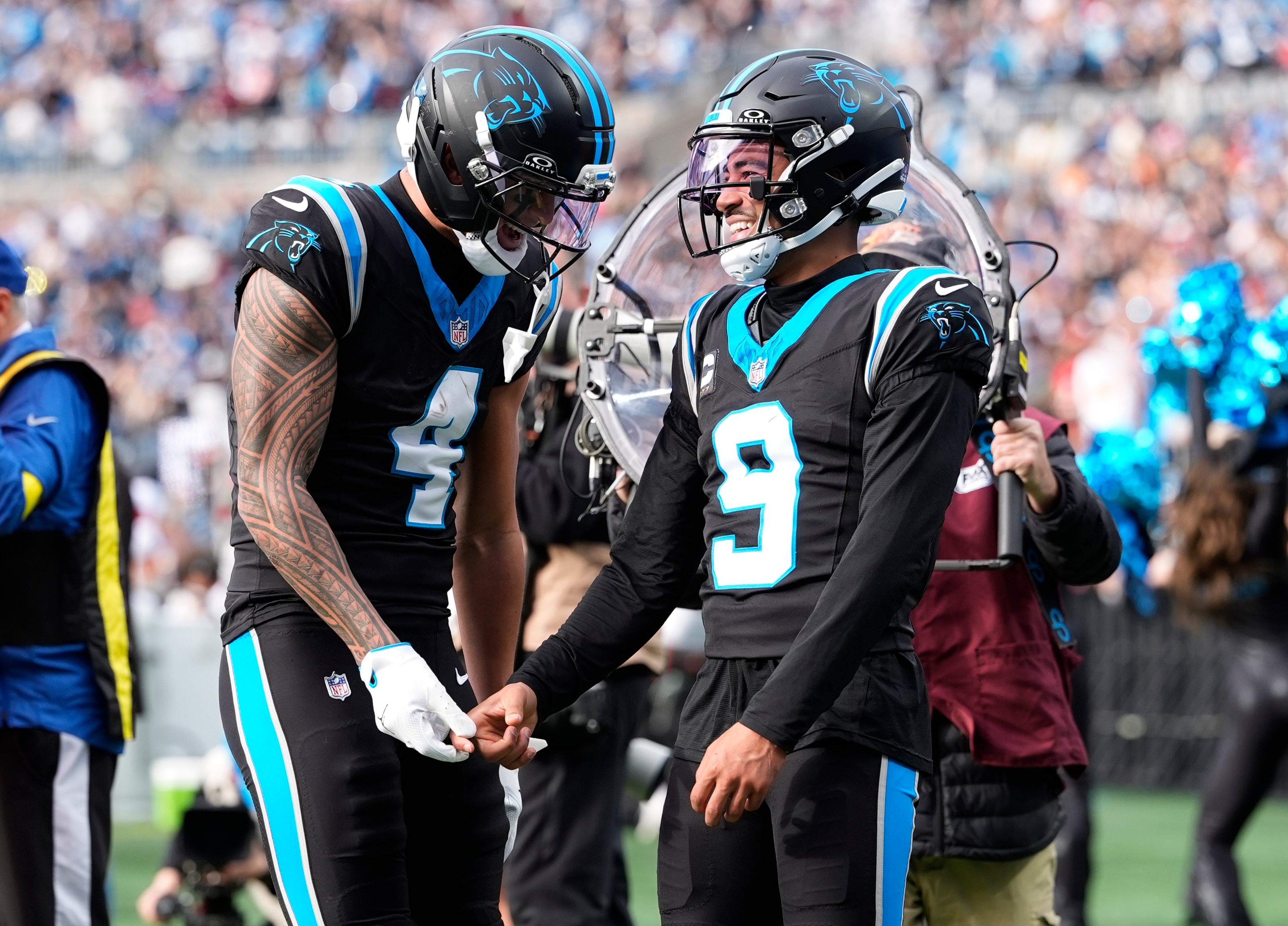 Dec 21, 2025; Charlotte, North Carolina, USA; Carolina Panthers wide receiver Tetairoa McMillan (4) and quarterback Bryce Young (9) celebrate after a play during the second half against the Tampa Bay Buccaneers at Bank of America Stadium.