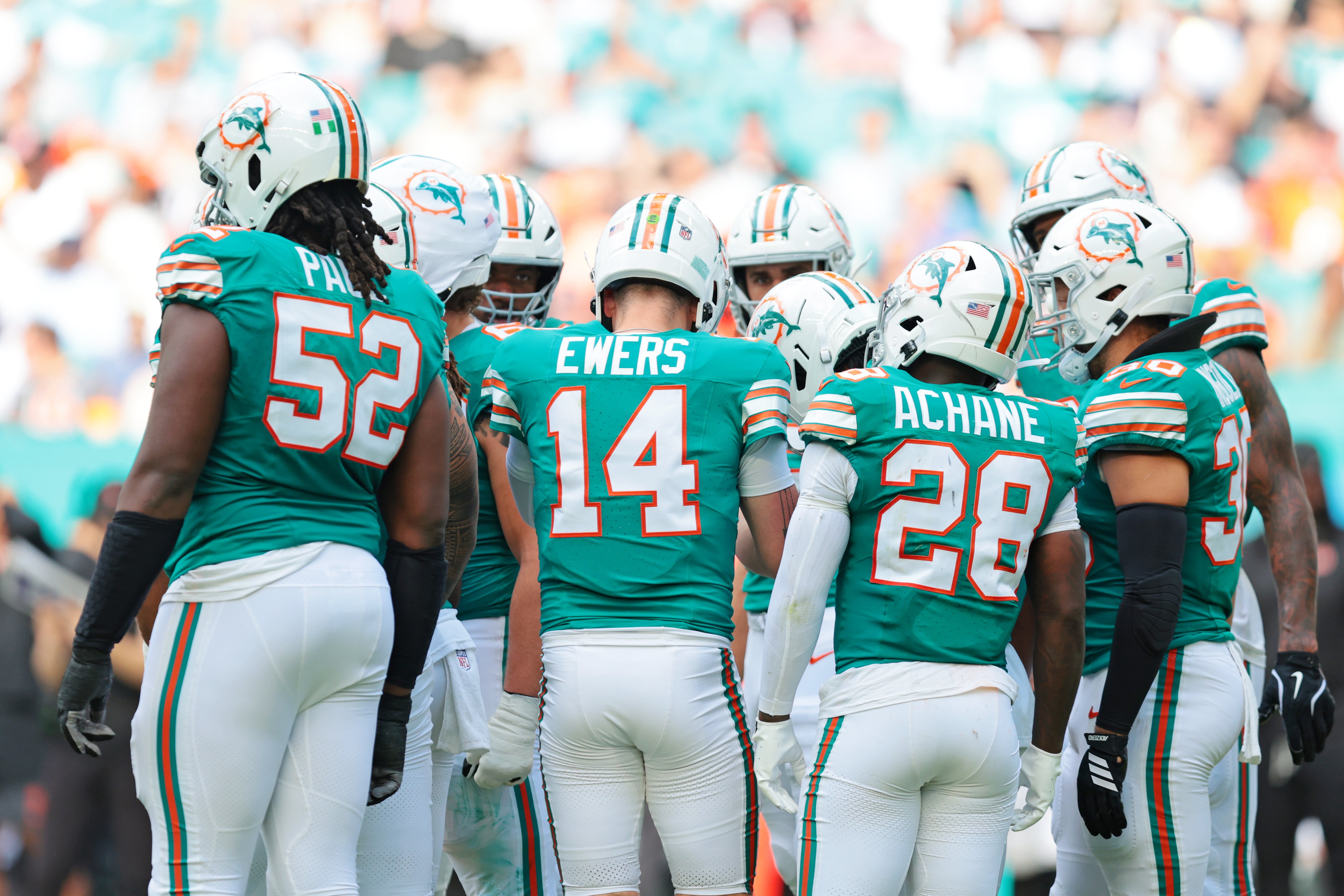 Dec 21, 2025; Miami Gardens, Florida, USA; Miami Dolphins quarterback Quinn Ewers (14) huddles up with teammates during the second quarter against the Cincinnati Bengals at Hard Rock Stadium.