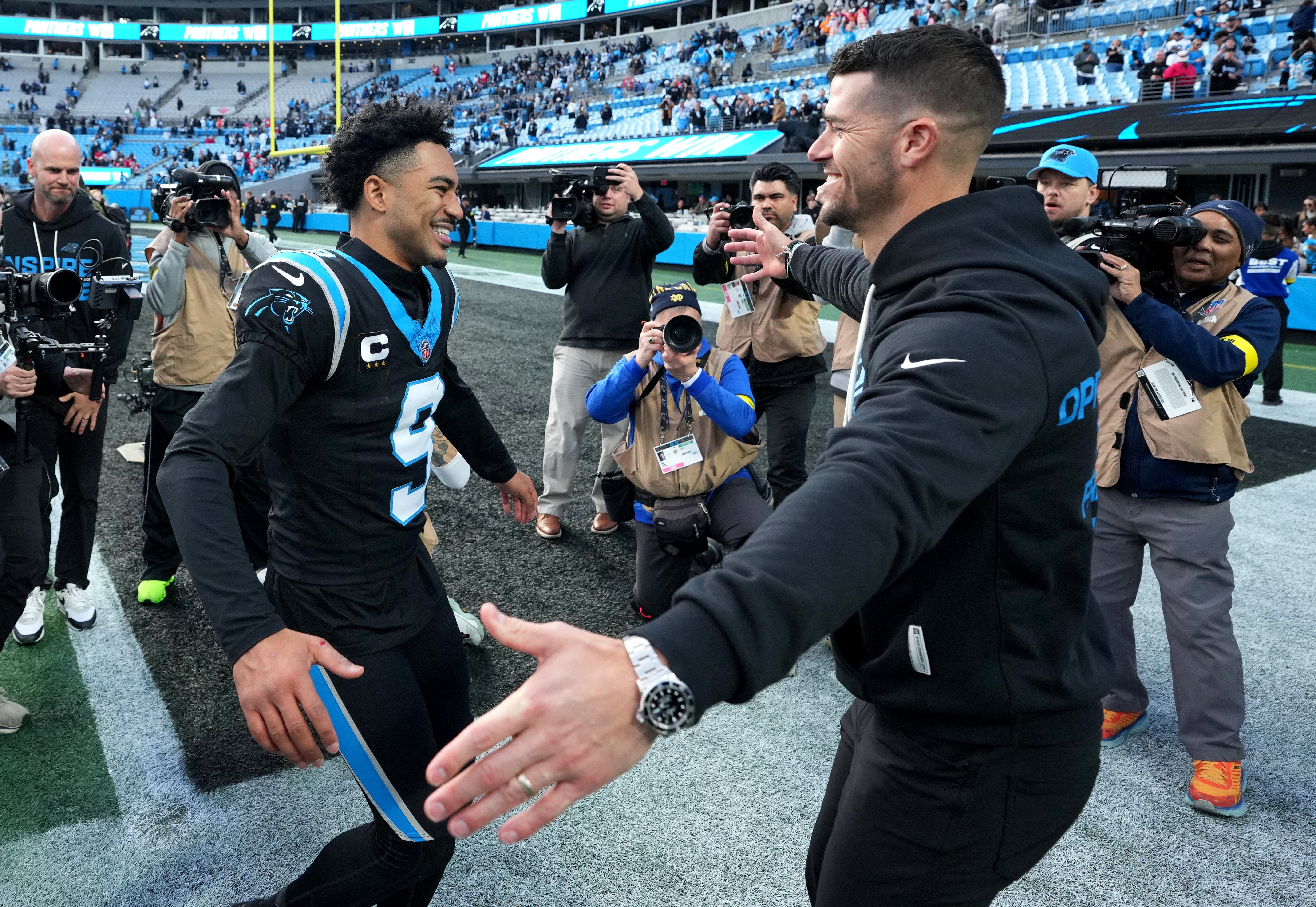 Dec 21, 2025; Charlotte, North Carolina, USA; Carolina Panthers head coach Dave Canales celebrates with quarterback Bryce Young (9) after a game against the Tampa Bay Buccaneers at Bank of America Stadium.