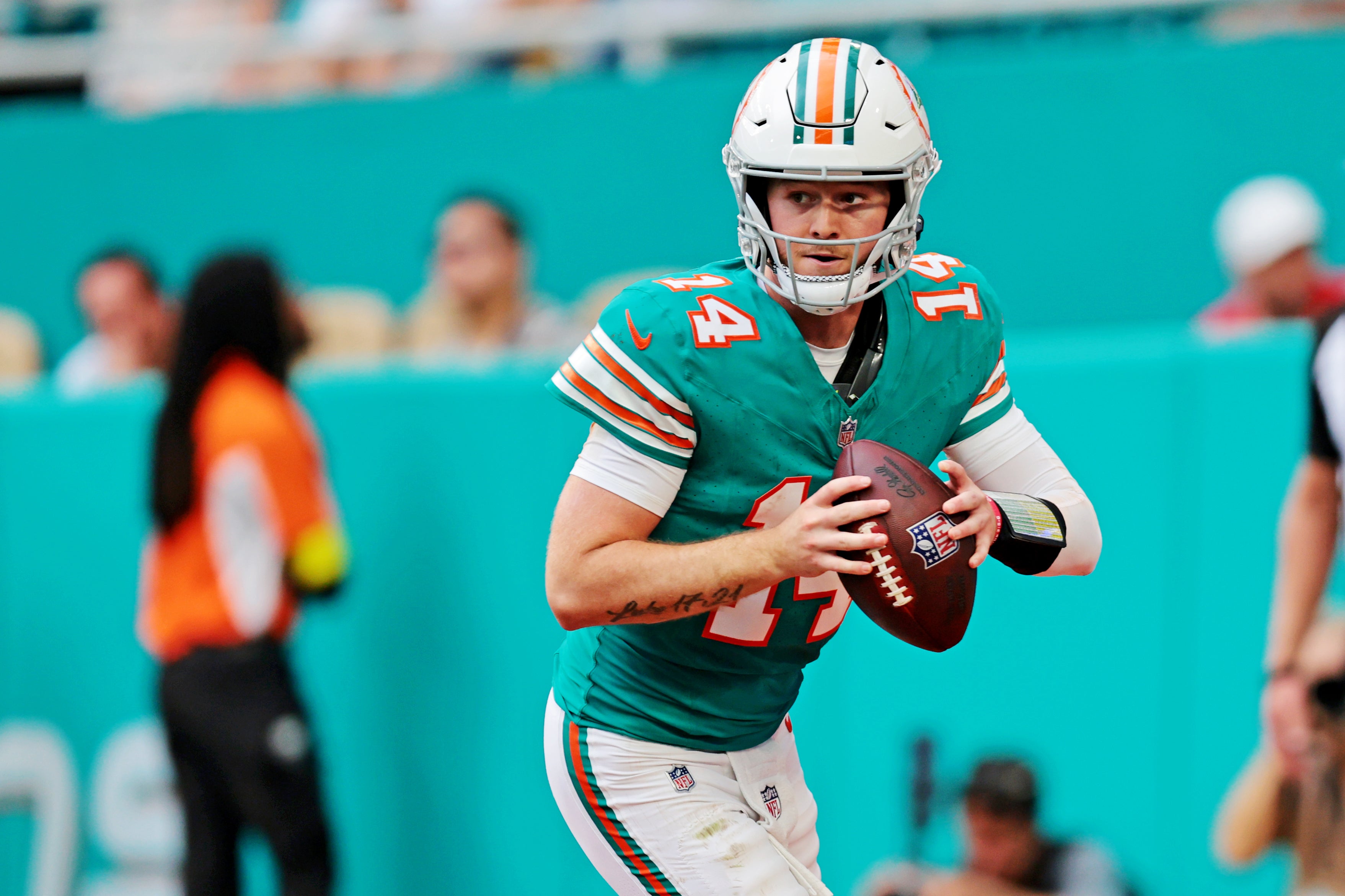 Dec 21, 2025; Miami Gardens, Florida, USA; Miami Dolphins quarterback Quinn Ewers (14) runs the ball during the fourth quarter against the Cincinnati Bengals at Hard Rock Stadium.