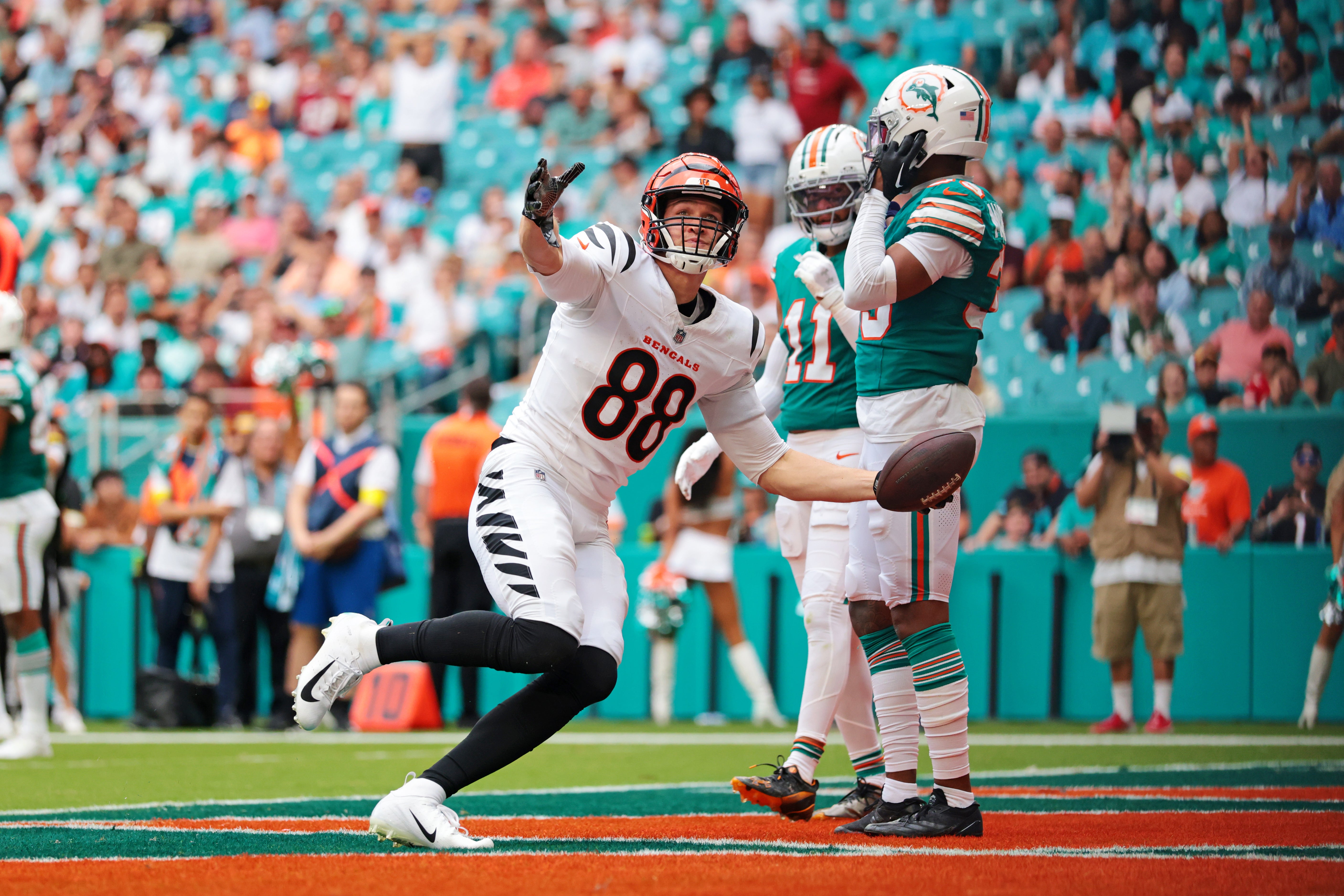 Dec 21, 2025; Miami Gardens, Florida, USA; Cincinnati Bengals tight end Mike Gesicki (88) catches a touchdown over Miami Dolphins cornerback Jason Marshall Jr. (33) during the fourth quarter at Hard Rock Stadium.