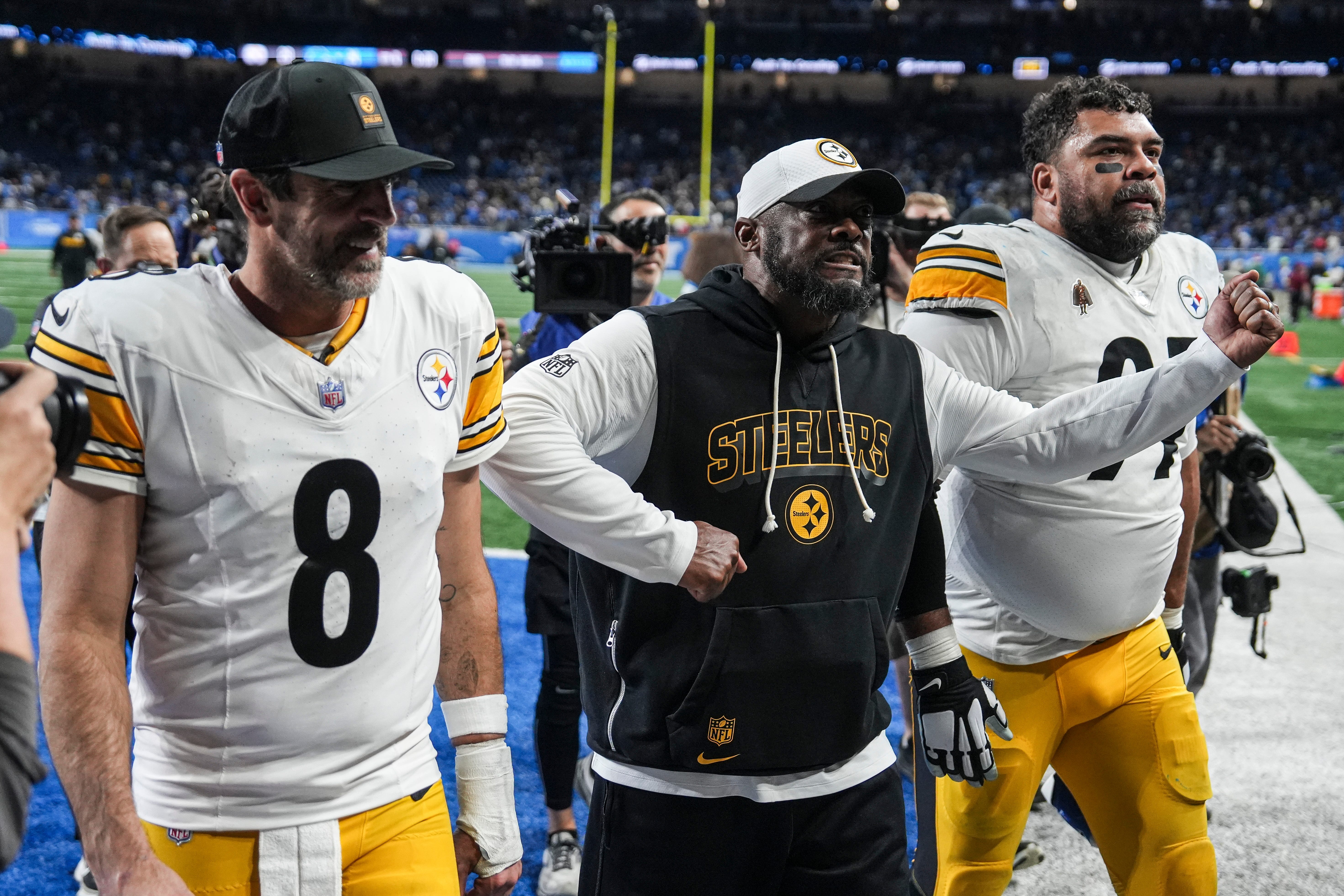 Pittsburgh Steelers Pittsburgh Steelers head coach Mike Tomlin, center, next to quarterback Aaron Rodgers (8) and defensive tackle Keeanu Benton (95) walk off the field after 29-24 win over Detroit Lions at Ford Field in Detroit on Sunday, Dec. 21, 2025.