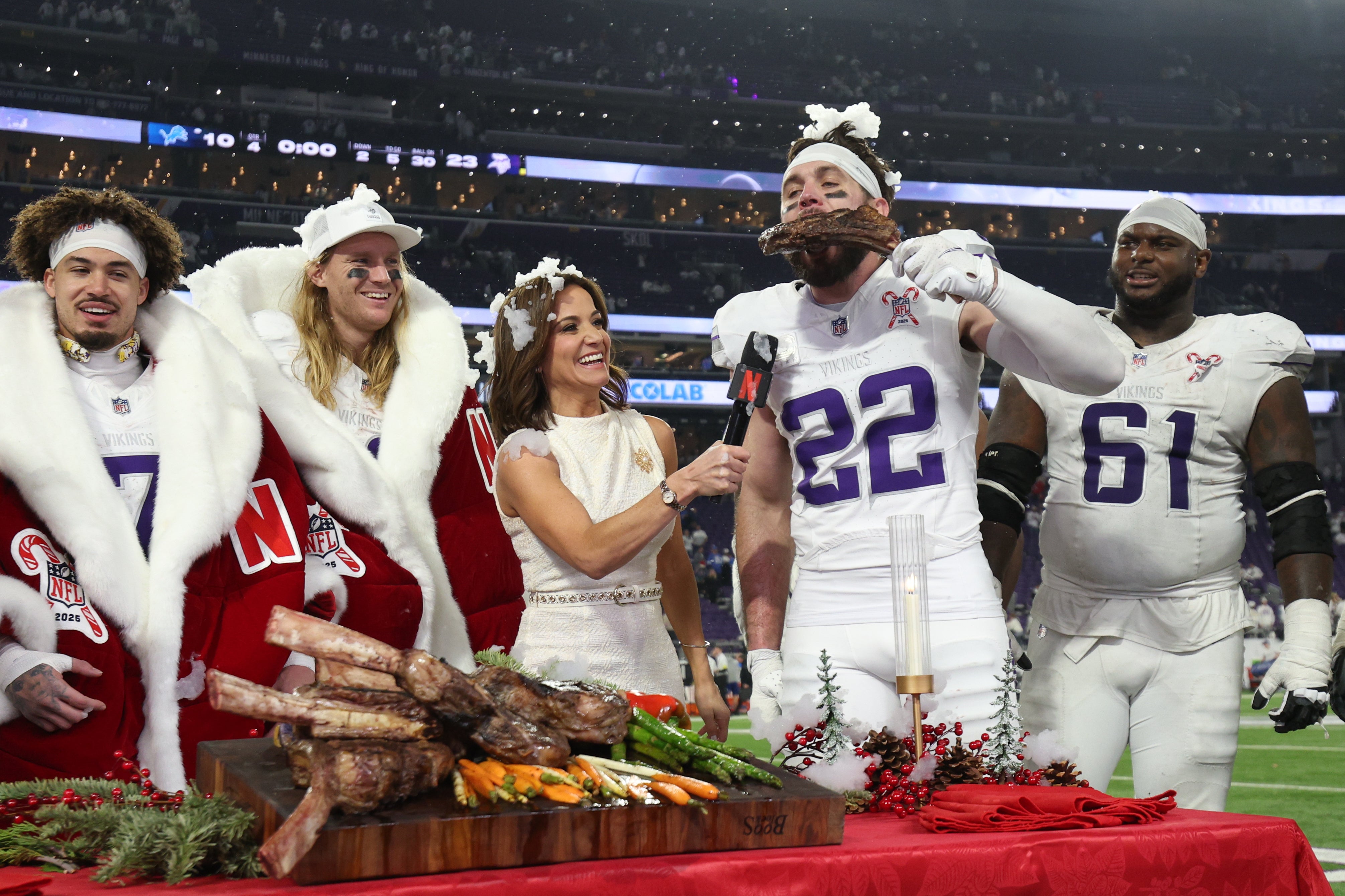 Dec 25, 2025; Minneapolis, Minnesota, USA; Minnesota Vikings safety Harrison Smith (22) eats a steak after the game against the Detroit Lions while being interviewed by Dianna Russini at U.S. Bank Stadium.