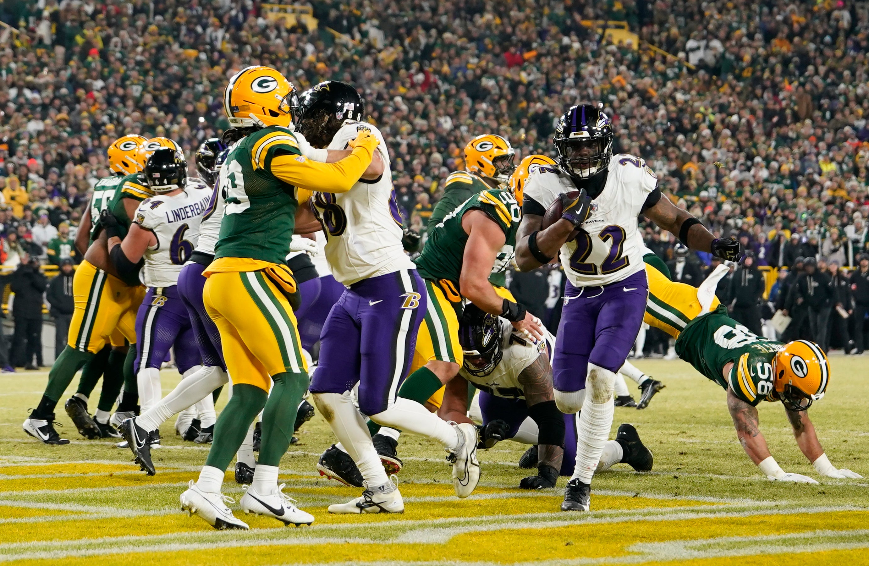 Dec 27, 2025; Green Bay, Wisconsin, USA; Baltimore Ravens running back Derrick Henry (22) runs for a touchdown during the second quarter against the Green Bay Packers at Lambeau Field.