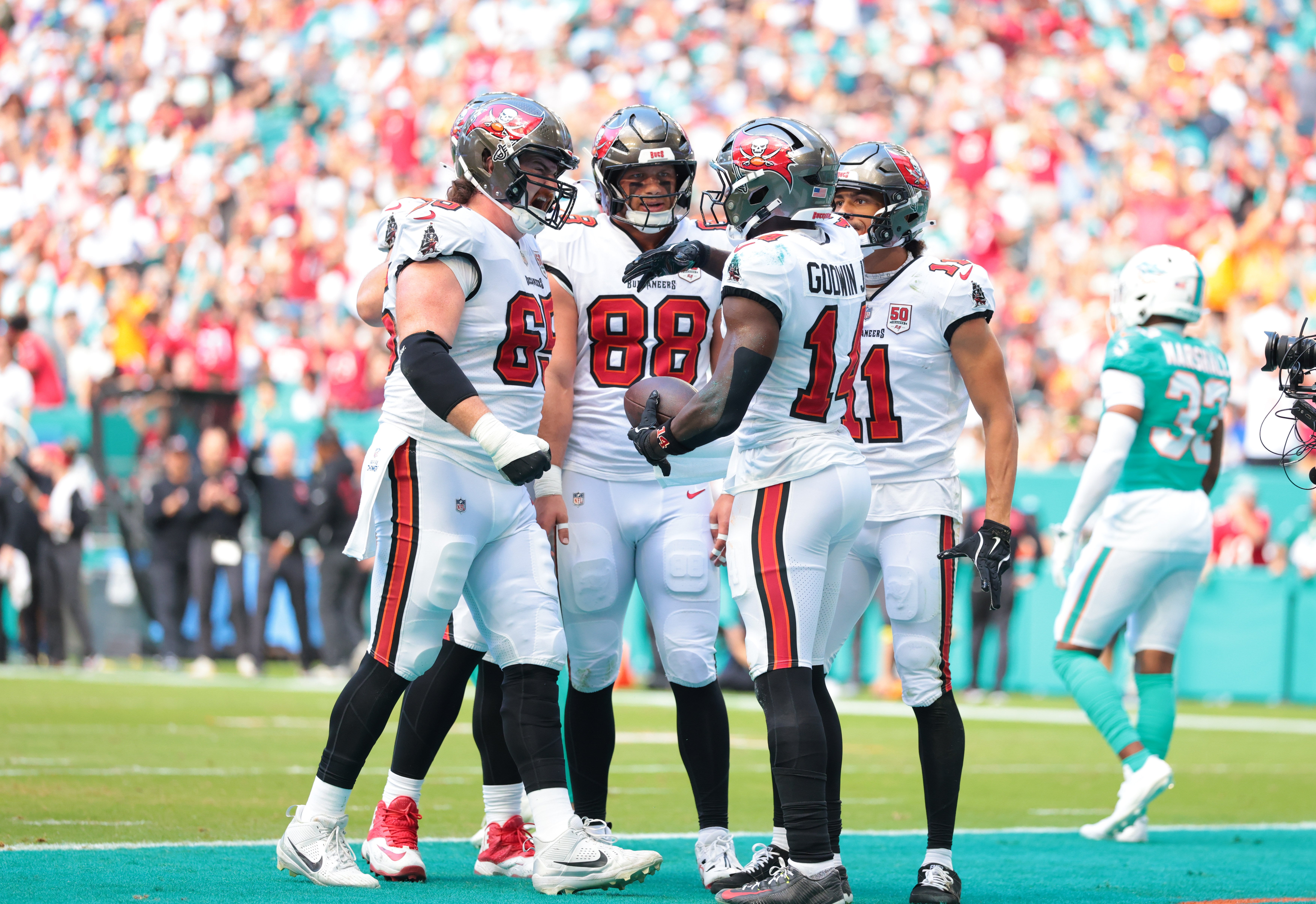 Dec 28, 2025; Miami Gardens, Florida, USA; Tampa Bay Buccaneers wide receiver Chris Godwin Jr. (14) celebrates a touchdown with teammates during the first quarter against the Miami Dolphins at Hard Rock Stadium.