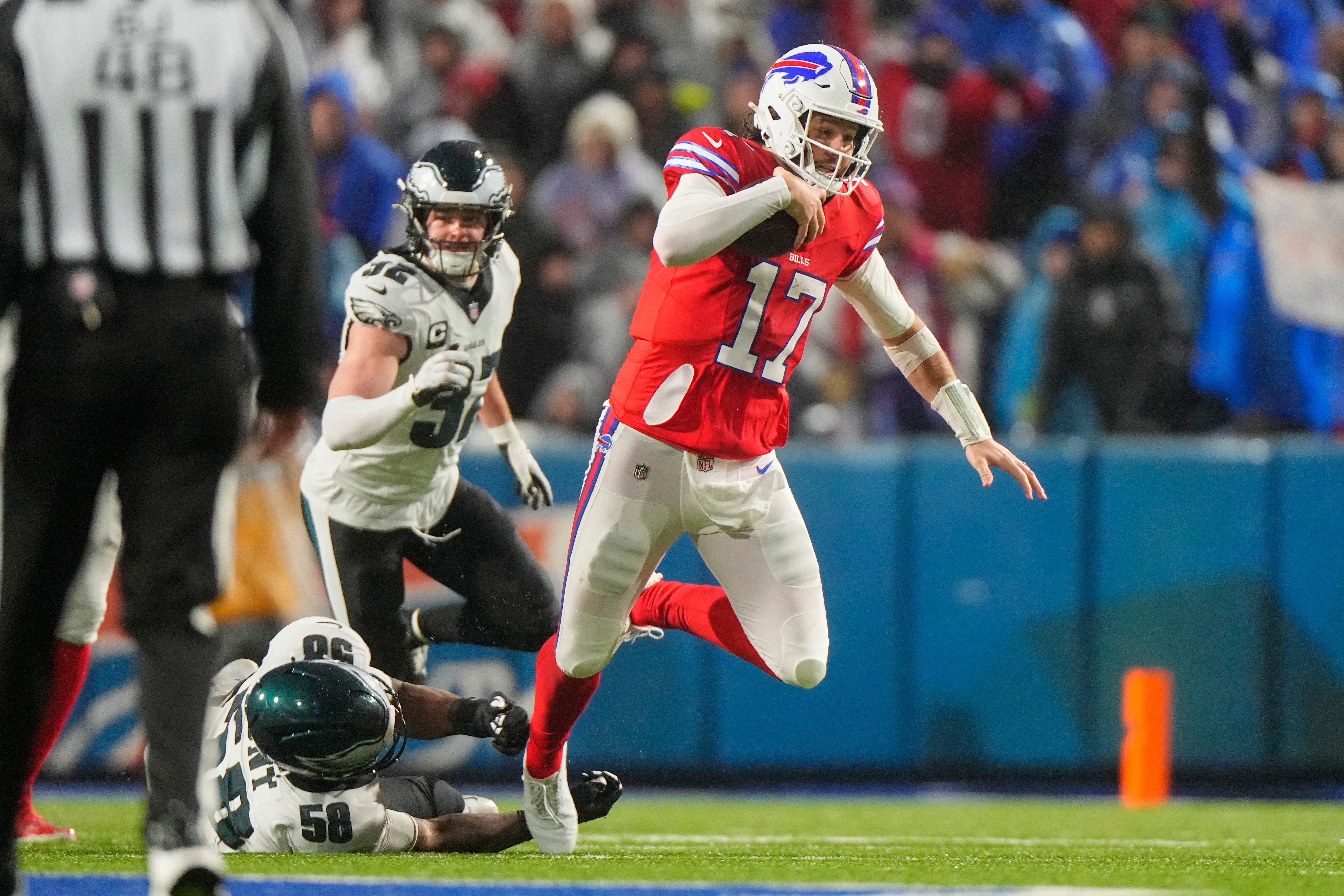 Dec 28, 2025; Orchard Park, New York, USA; Philadelphia Eagles linebacker Jalyx Hunt (58) tackles Buffalo Bills quarterback Josh Allen (17) during the second quarter at Highmark Stadium.