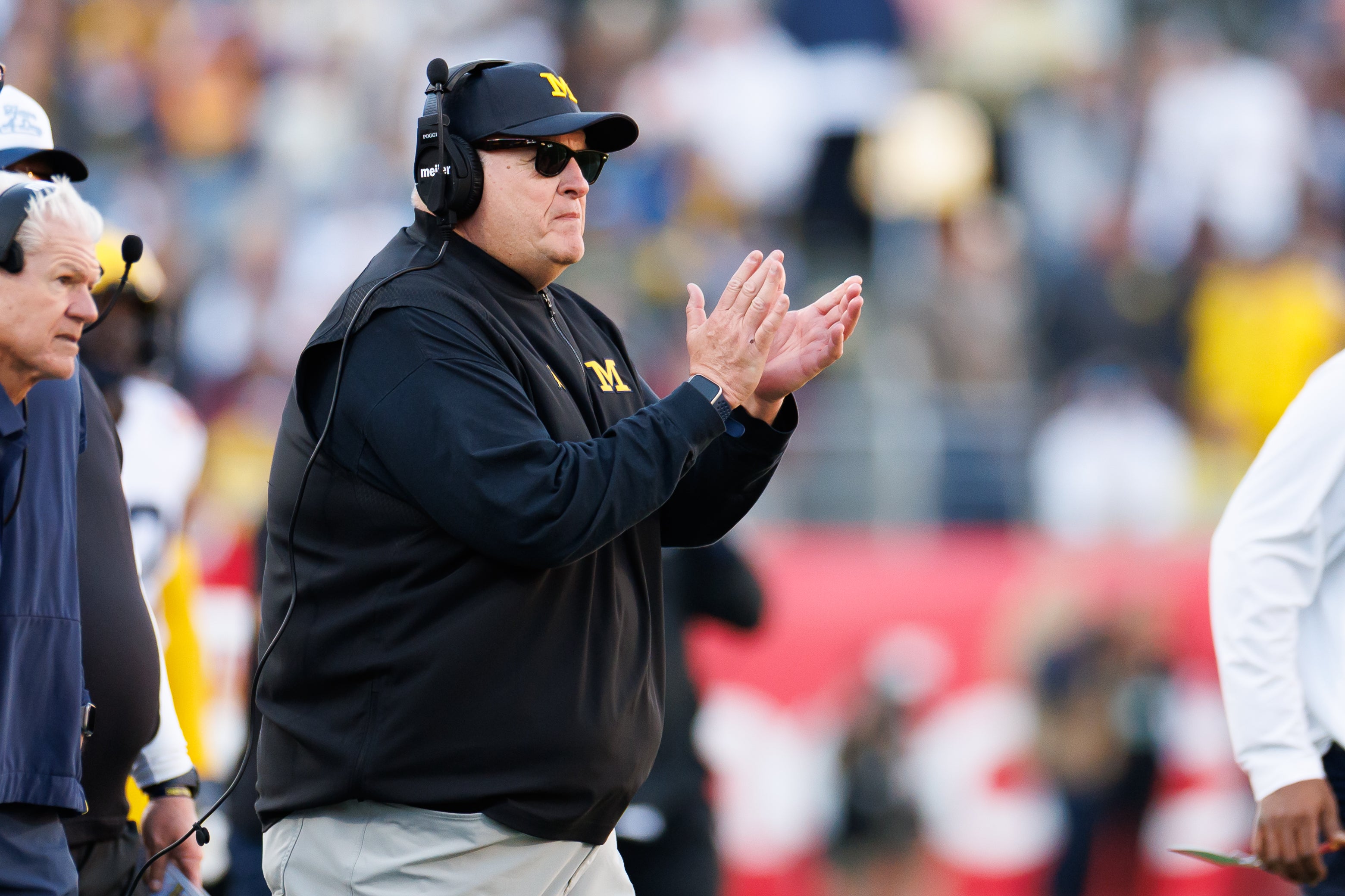 Dec 31, 2025; Orlando, FL, USA; Michigan Wolverines interim head coach Biff Poggi celebrates after a play against the Texas Longhorns during the first half at Camping World Stadium. Mandatory Credit: Matt Pendleton-Imagn Images