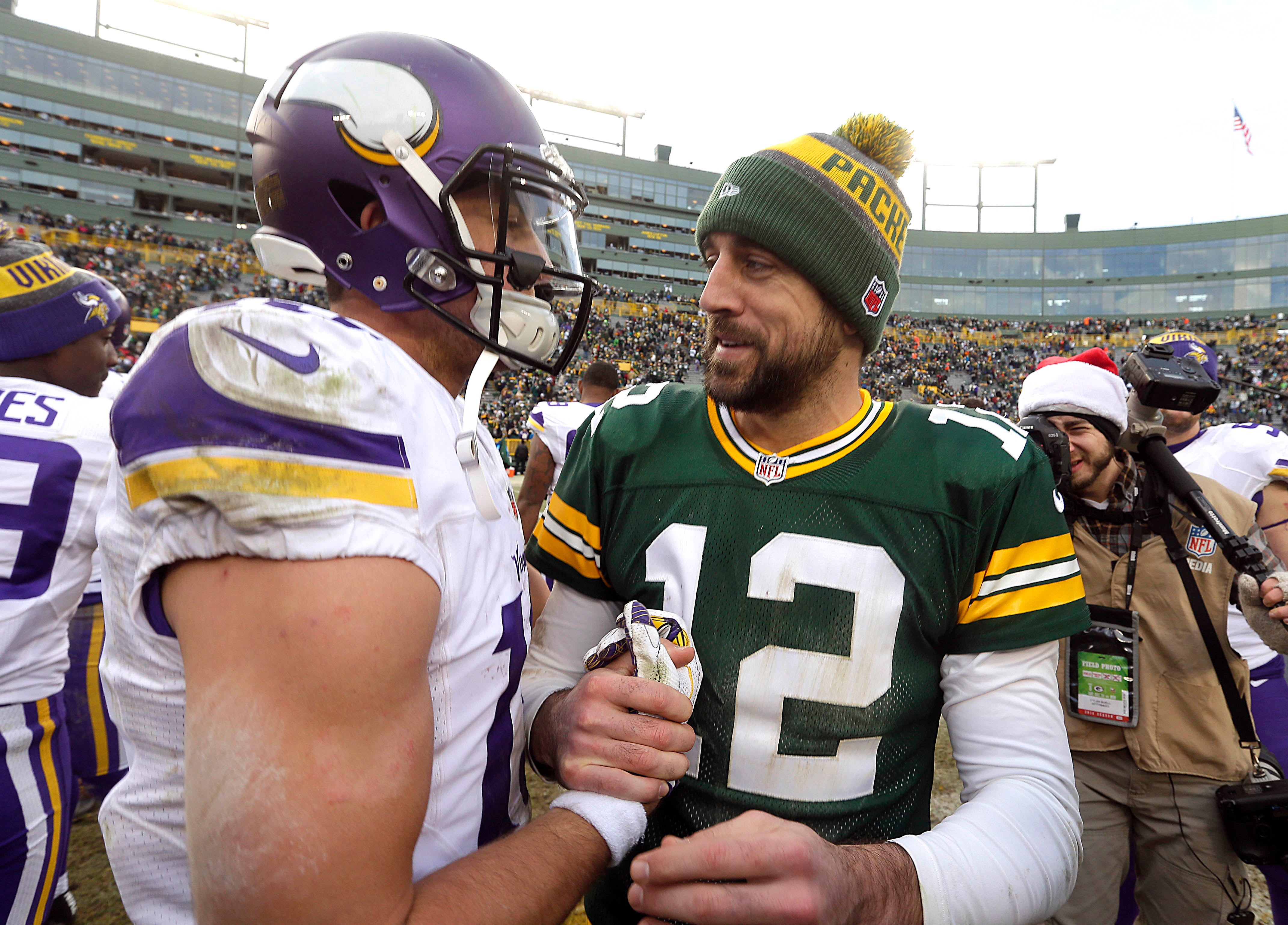 Dec 24, 2016; Green Bay, WI, USA; Green Bay Packers quarterback Aaron Rodgers (12) greets Minnesota Vikings wide receiver Adam Thielen (left) after the Packers 38-25 victory over the Vikings at Lambeau Field.