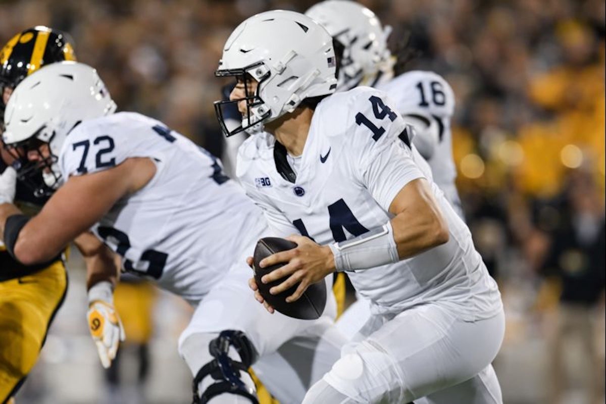 Oct 18, 2025; Iowa City, Iowa, USA; Penn State Nittany Lions quarterback Jaxon Smolik (14) scrambles during the first quarter against the Iowa Hawkeyes at Kinnick Stadium. Mandatory Credit: Jeffrey Becker-Imagn Images