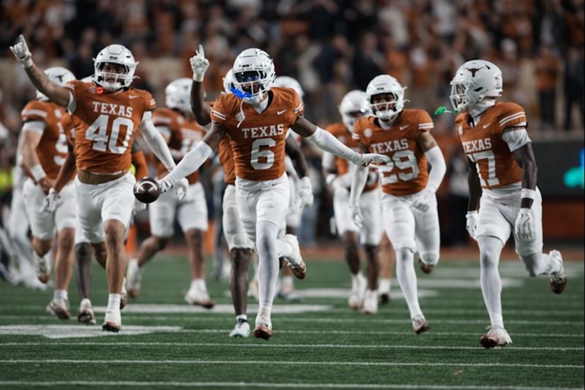Nov 28, 2025; Austin, Texas, USA; Texas Longhorns defensive back Kobe Black (6) and teammates react after making an interception during the second half against the Texas A&M Aggies at Darrell K Royal-Texas Memorial Stadium. Mandatory Credit: Scott Wachter-Imagn Images