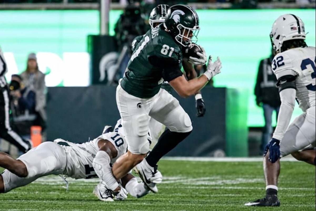 Michigan State's Michael Masunas catches a pass as Penn State's Dejuan Lane, left, attempts the tackle during the third quarter on Saturday, Nov. 15, 2025, at Spartan Stadium in East Lansing.