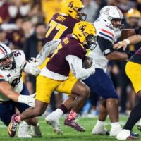 Nov 28, 2025; Tempe, Arizona, USA; Arizona State Sun Devils running back Raleek Brown (3) runs the ball against Arizona Wildcats defensive lineman Mays Pese (99) in the first half during the 99th Territorial Cup at Mountain America Stadium. Mandatory Credit: Mark J. Rebilas-Imagn Images