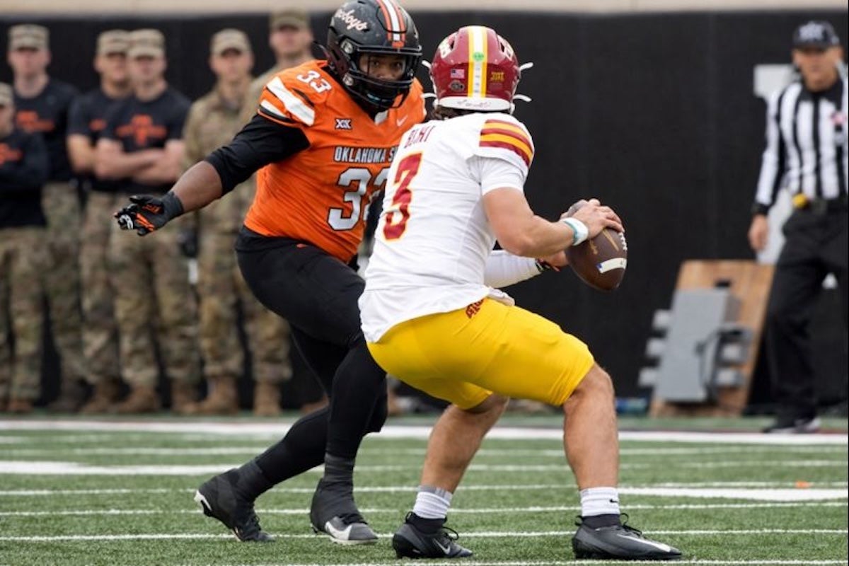 Oklahoma State's Kyran Duhon (33) pressures Iowa State's Rocco Becht (3) in the first half of the college football game between the Oklahoma State Cowboys and the Iowa State Cyclones at Boone Pickens Stadium in Stillwater, Okla., Saturday Nov. 29, 2025.
