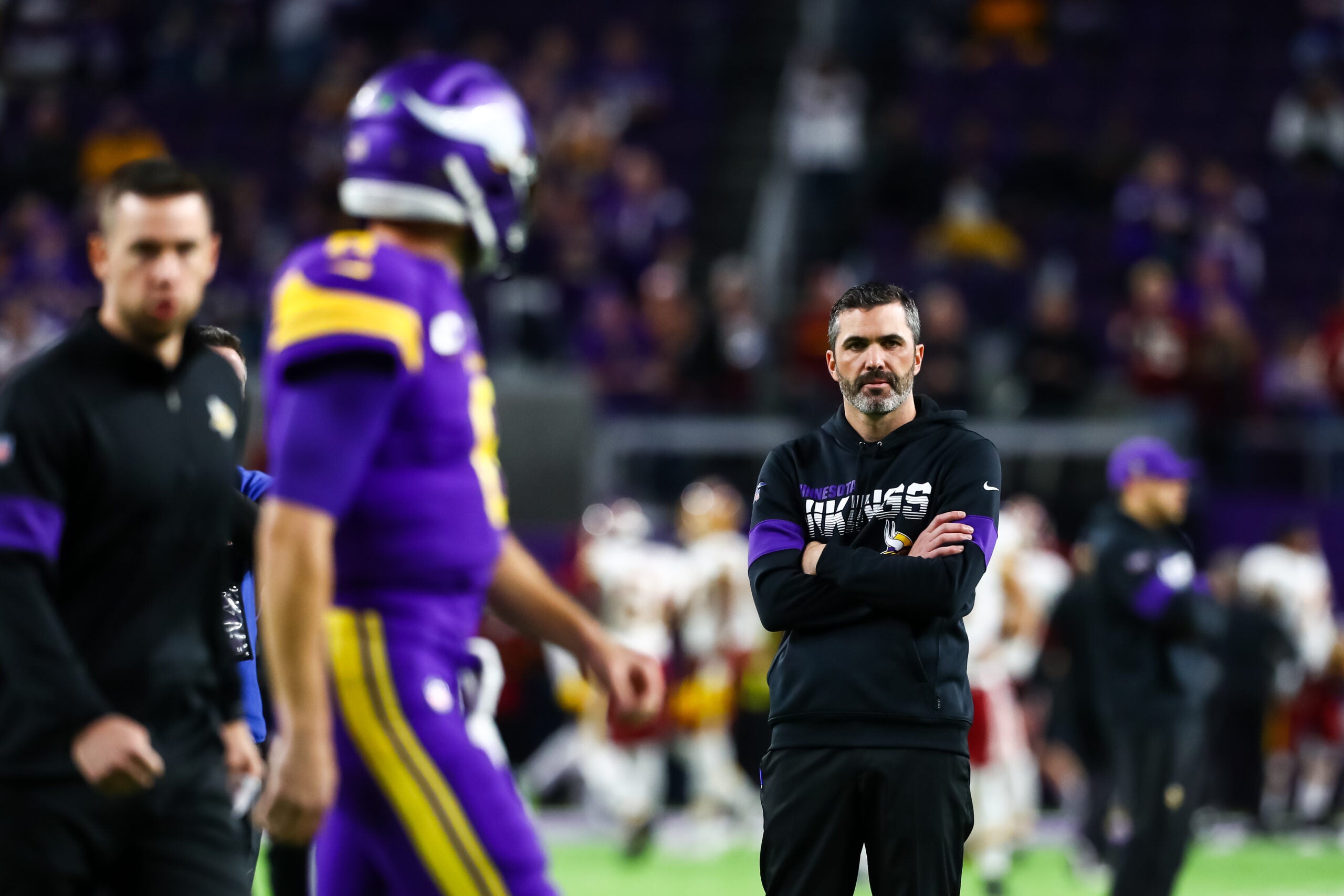 Oct 24, 2019; Minneapolis, MN, USA; Minnesota Vikings quarterback Kirk Cousins (8) participates in warm ups while offensive coordinator Kevin Stefanski looks on before the start of a game against the Washington Redskins at U.S. Bank Stadium.