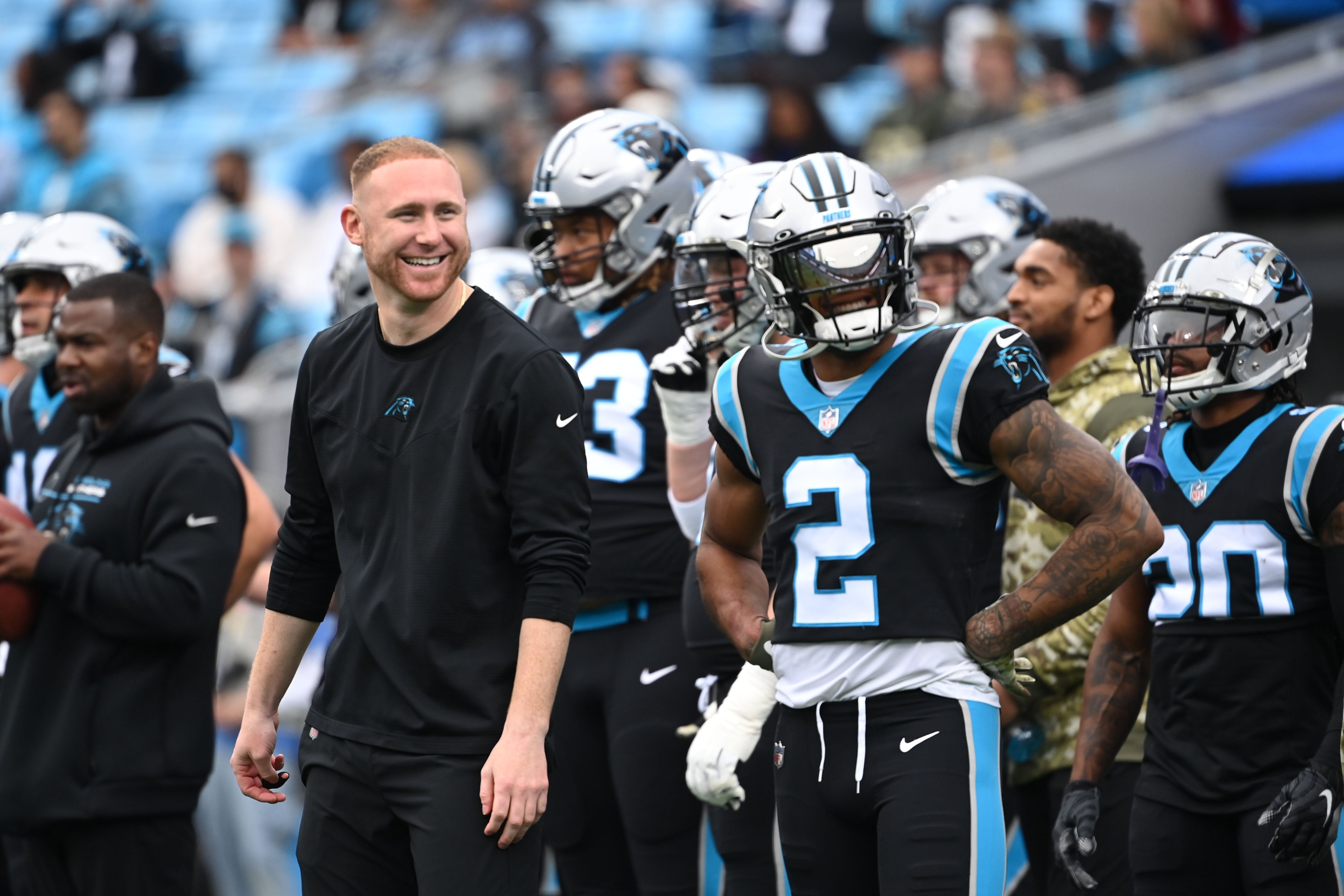 Nov 21, 2021; Charlotte, North Carolina, USA; Carolina Panthers assistant coach Joe Brady and wide receiver D.J. Moore (2) on the field before the game at Bank of America Stadium.