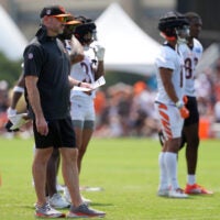 Jul 26, 2024; Cincinnati, OH, USA; Cincinnati Bengals offensive coordinator Dan Pitcher watches play during training camp practice at Kettering Health Practice Fields.