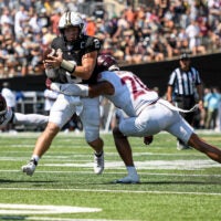 Aug 31, 2024; Nashville, Tennessee, USA; Vanderbilt Commodores quarterback Diego Pavia (2) fumbles the ball after being hit by Virginia Tech Hokies linebacker Caleb Woodson (20) during the second half at FirstBank Stadium.
