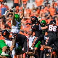 Sep 14, 2024; Corvallis, Oregon, USA; Oregon Ducks defensive lineman Tionne Gray (50) with pressure on Oregon State Beavers quarterback Gevani McCoy (4) during the second half at Reser Stadium. Mandatory Credit: Craig Strobeck-Imagn Images