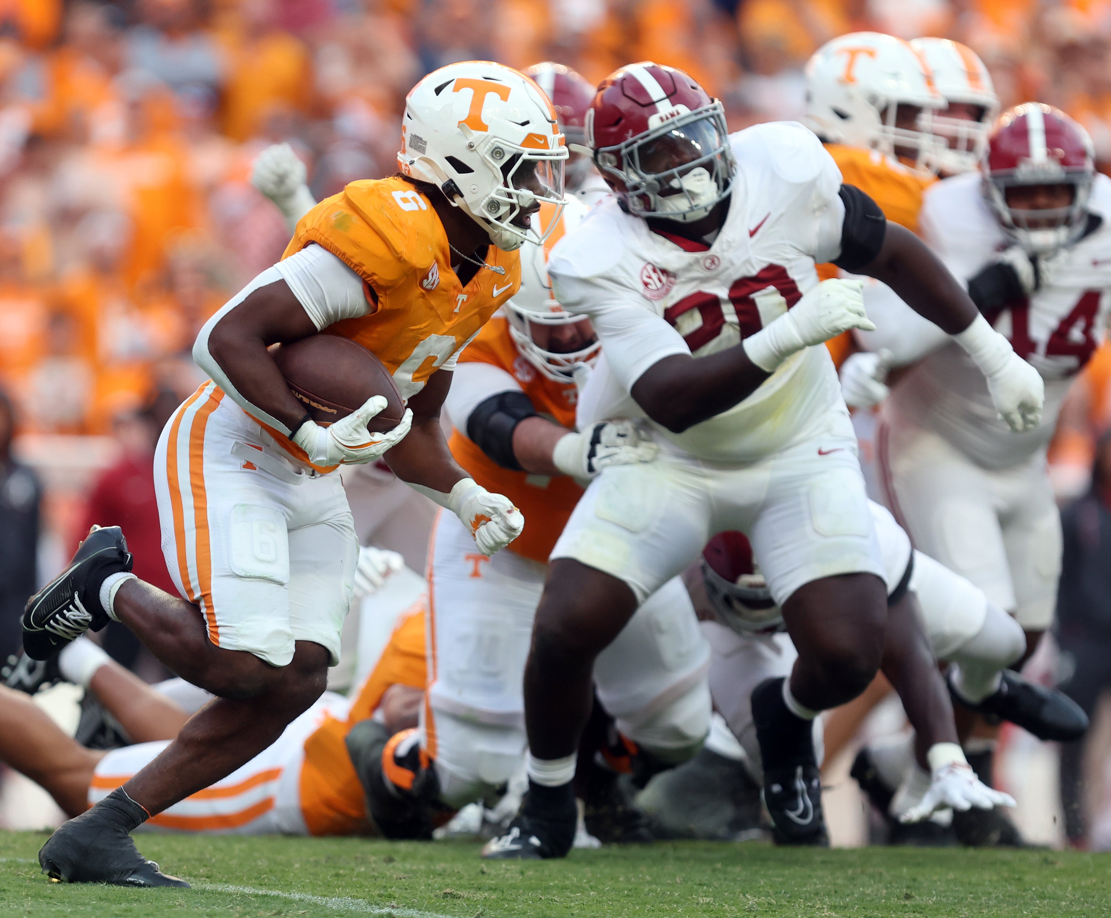 Oct 19, 2024; Knoxville, Tennessee, USA; Tennessee Volunteers running back Dylan Sampson (6) runs the ball against Alabama Crimson Tide defensive lineman Jah-Marien Latham (20) in the third quarter at Neyland Stadium.